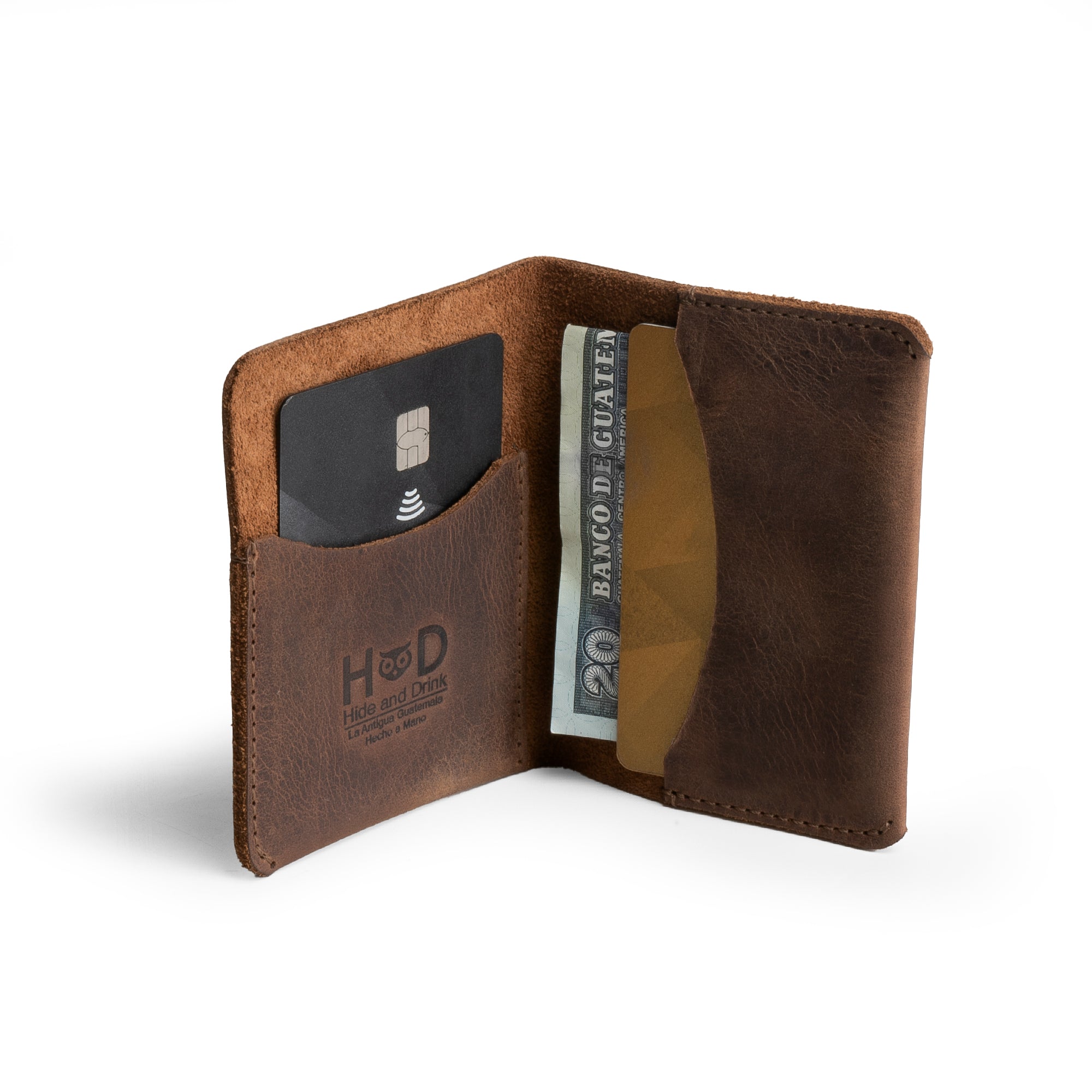Hide & Drink's Bifold Slim Card Holder features a sleek design for credit card storage and cash organization. Made from full grain leather, this minimalist wallet is hand cut and hand sewn, a perfect choice for those who appreciate artisan craftsmanship. Ideal for everyday use, it's a practical cash case that embodies small batch production and artisan quality from La Antigua Guatemala.