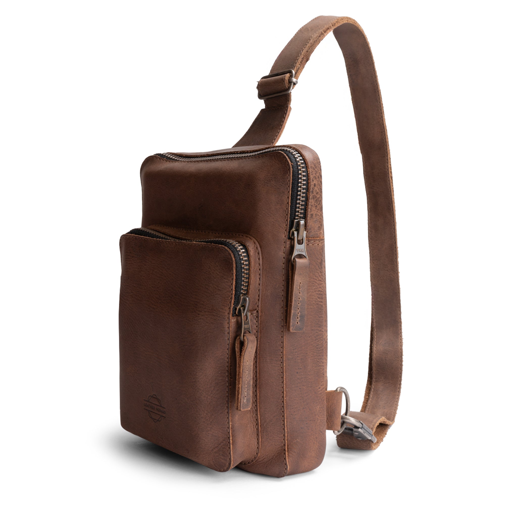 Front view of the Traveler Sling Bag by Leather Nomad, showcasing its trendy and stylish design made of full grain leather. This fashionable accessory is perfect for both men and women, ideal for everyday use. Hand cut and hand sewn, each bag is crafted with care in La Antigua Guatemala, featuring a fire branded logo and small batch production.