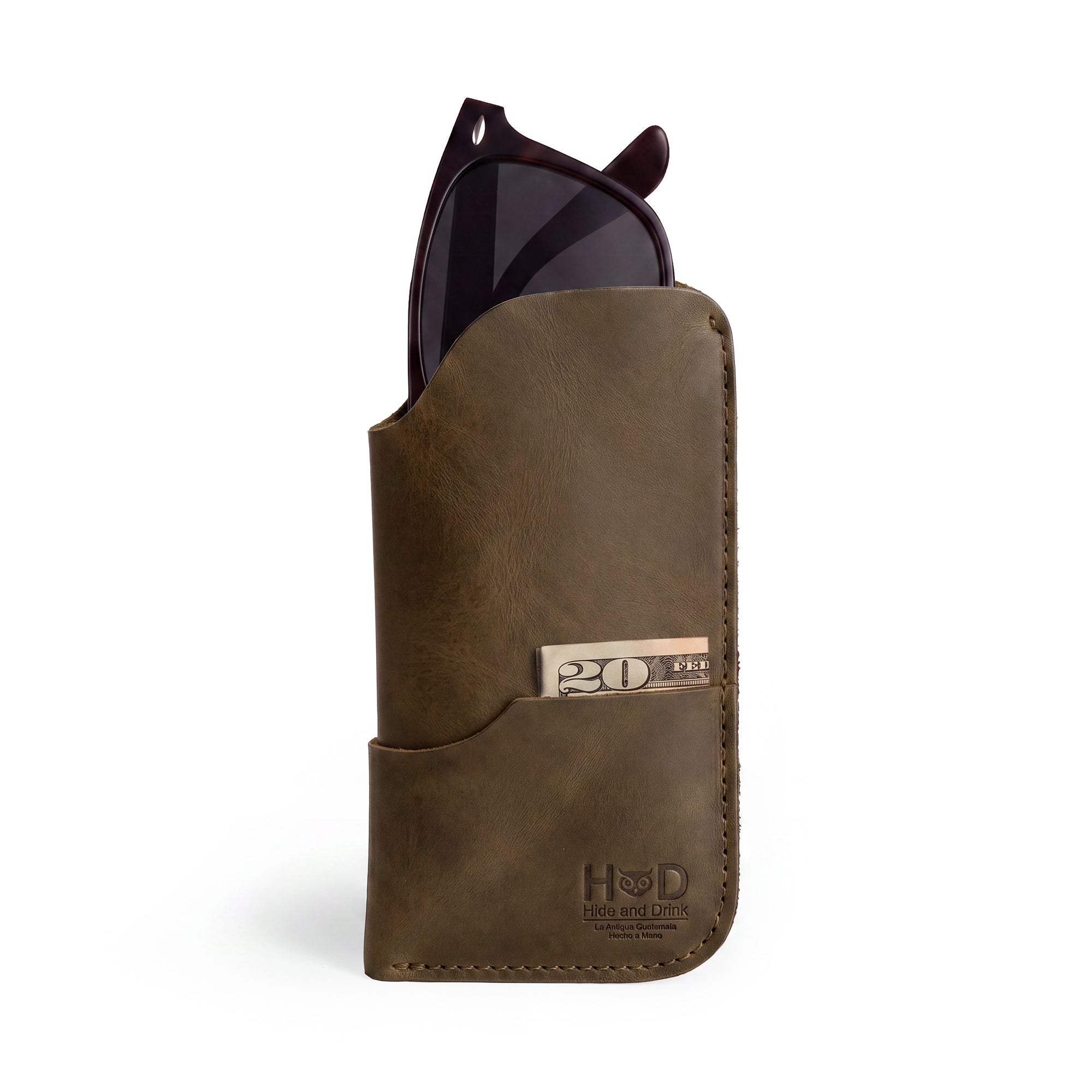 The Hide & Drink Sunglass Case & Wallet in rich green leather, reflecting artisan artistry. This Rustic Sunglasses Case & Wallet is crafted of Full Grain Leather, perfect for a practical eyeglasses sleeve while traveling, made with care in La Antigua Guatemala & Oaxaca Mexico.