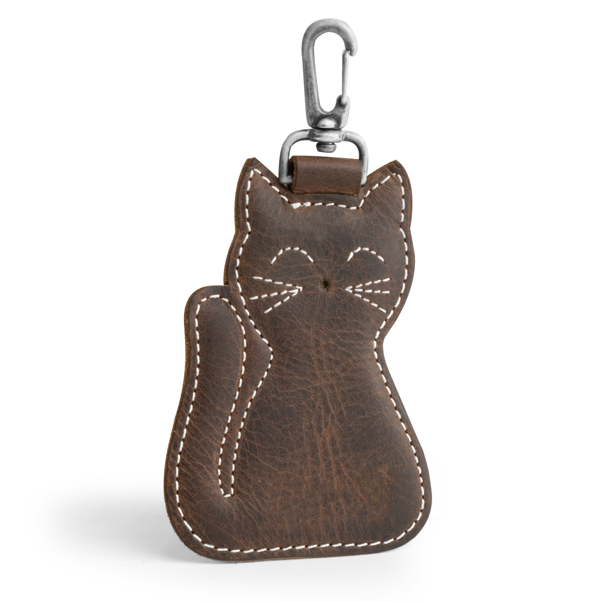 A stylish Cat Keychain by Hide & Drink, showcasing a charming cat-shaped design. This Cat-Shaped Keychain serves as a functional key organizer and a delightful stuffed animal-shaped ornament, crafted from high-quality Full Grain Leather. Handmade in La Antigua Guatemala and Oaxaca, Mexico, it features meticulous small batch production with hand cut and hand sewn details, and a fire-branded logo that highlights its artisan quality.