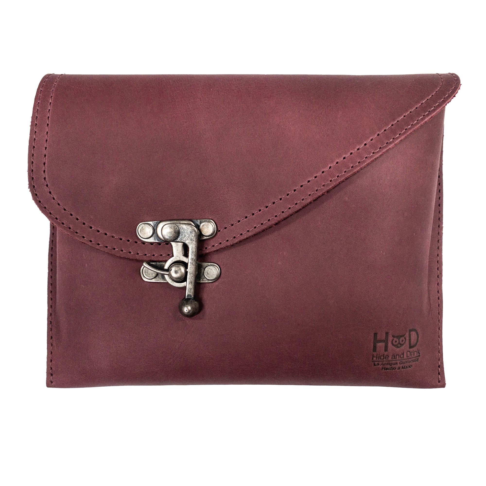 Front view of the Petite Vintage Clutch Bag by Hide & Drink, showcasing its sleek design and vintage clasp. This handmade clutch is crafted from full grain leather, perfect as a stylish evening bag or travel accessory. Ideal for those who appreciate artisan-made products from small batch production in La Antigua Guatemala & Oaxaca Mexico.