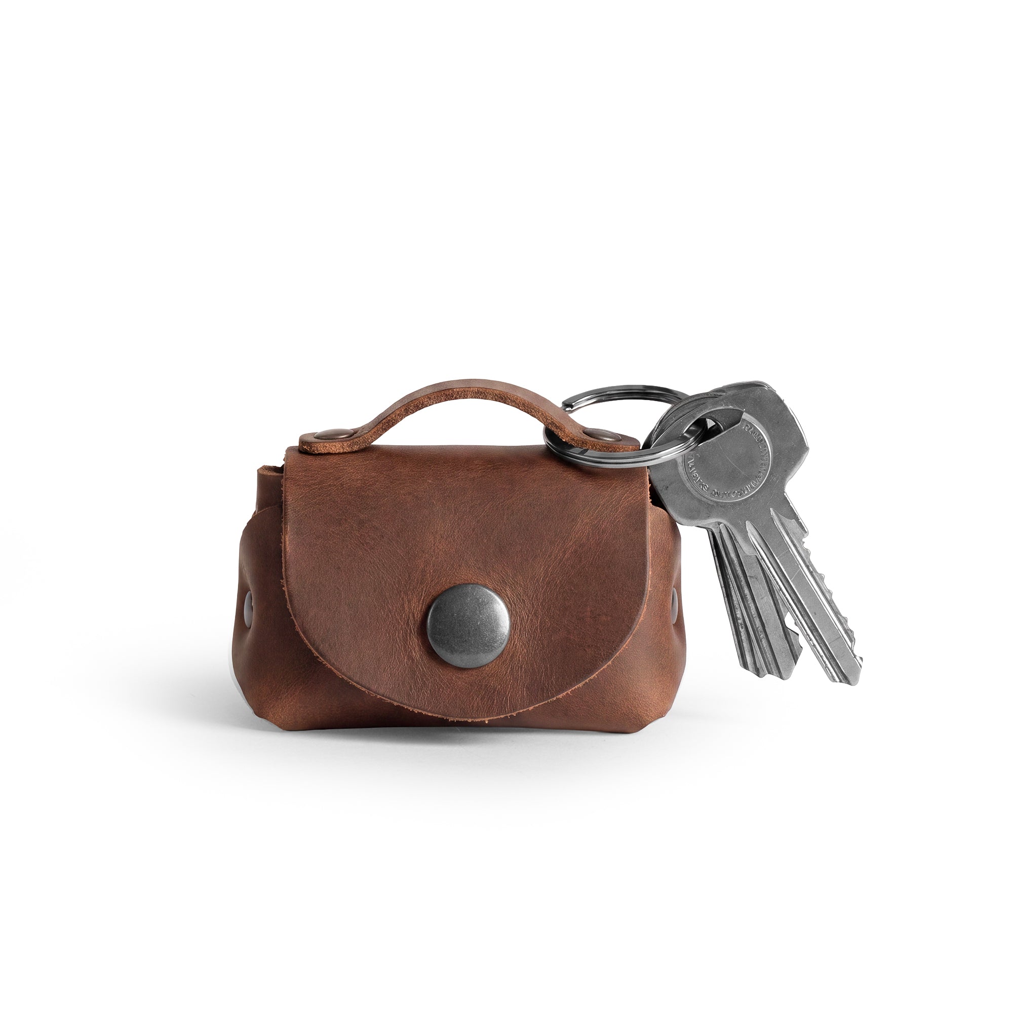 Tiny Handbag Keychain featuring a rustic design with key ring holder, crafted from full grain leather by Hide & Drink. This artisan-made Tiny Handbag with Key Ring Holder, Full Grain Leather, showcases small batch production, hand cut, hand sewn, and fire branded techniques, handmade in La Antigua Guatemala & Oaxaca Mexico.