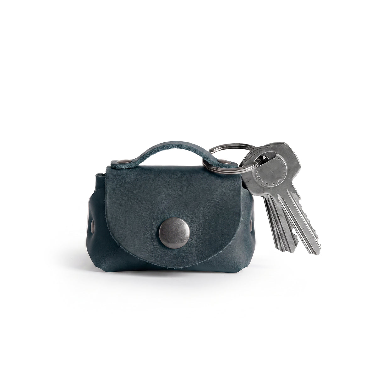 Tiny Handbag Keychain by Hide & Drink displayed in a stylish way, showcasing its Full Grain Leather and Key Ring Holder design, perfect for those who love unique handmade accessories from StockyardX. This artisan piece, crafted with care in La Antigua Guatemala, reflects the quality of small batch production.