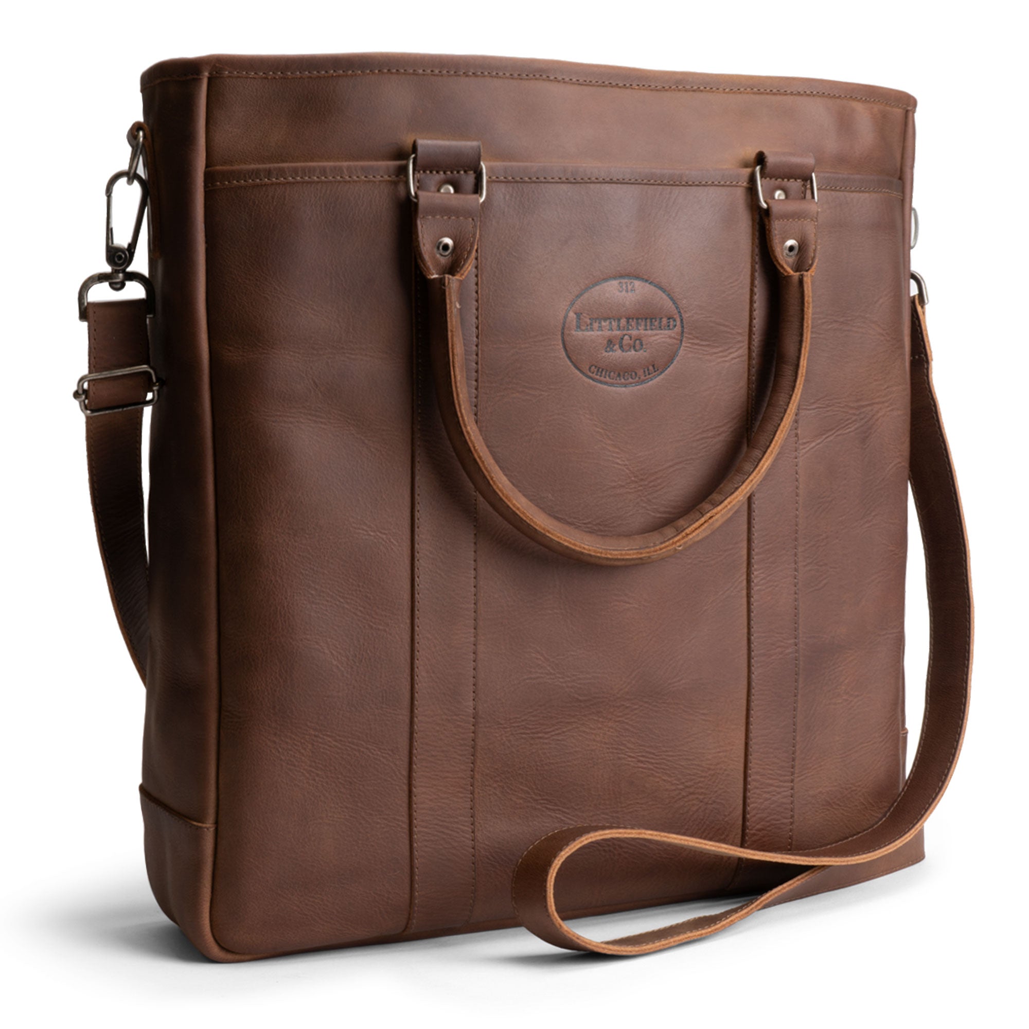 Littlefield & Co. Vintage Tote Vertical Briefcase & Laptop Carrier showcased in rich brown full grain leather, perfect for work and travel. This stylish vertical briefcase features a classic design, embodying small batch production, handmade in La Antigua Guatemala. Ideal for easy access, this artisan-crafted bag complements any professional or casual outing.