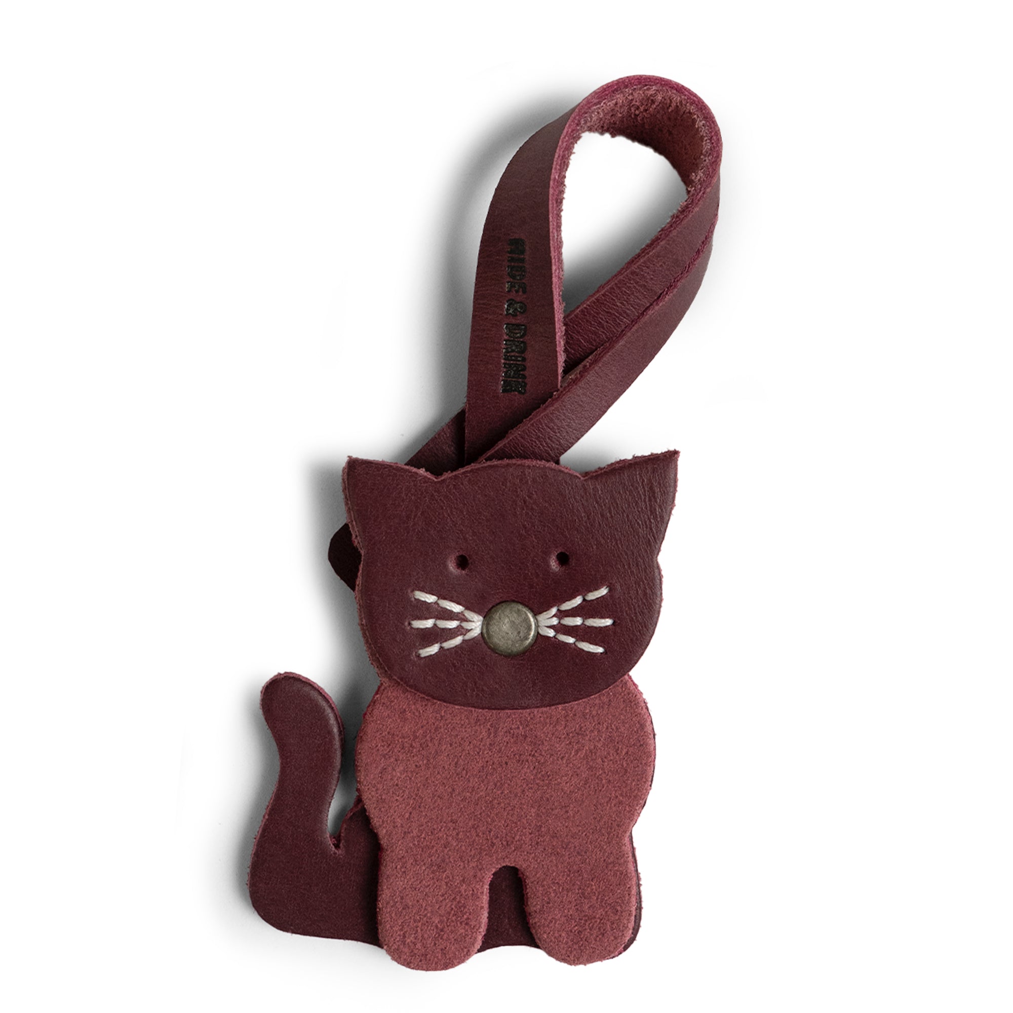 Hide & Drink Bag Charms showcasing a charming cat design, perfect charm for handbags. An ideal purse charm for tote & backpacks, crafted from full grain leather. Each piece embodies StockyardX's small batch production principles, featuring hand cut, hand sewn craftsmanship and fire branding, handmade in La Antigua Guatemala & Oaxaca Mexico.