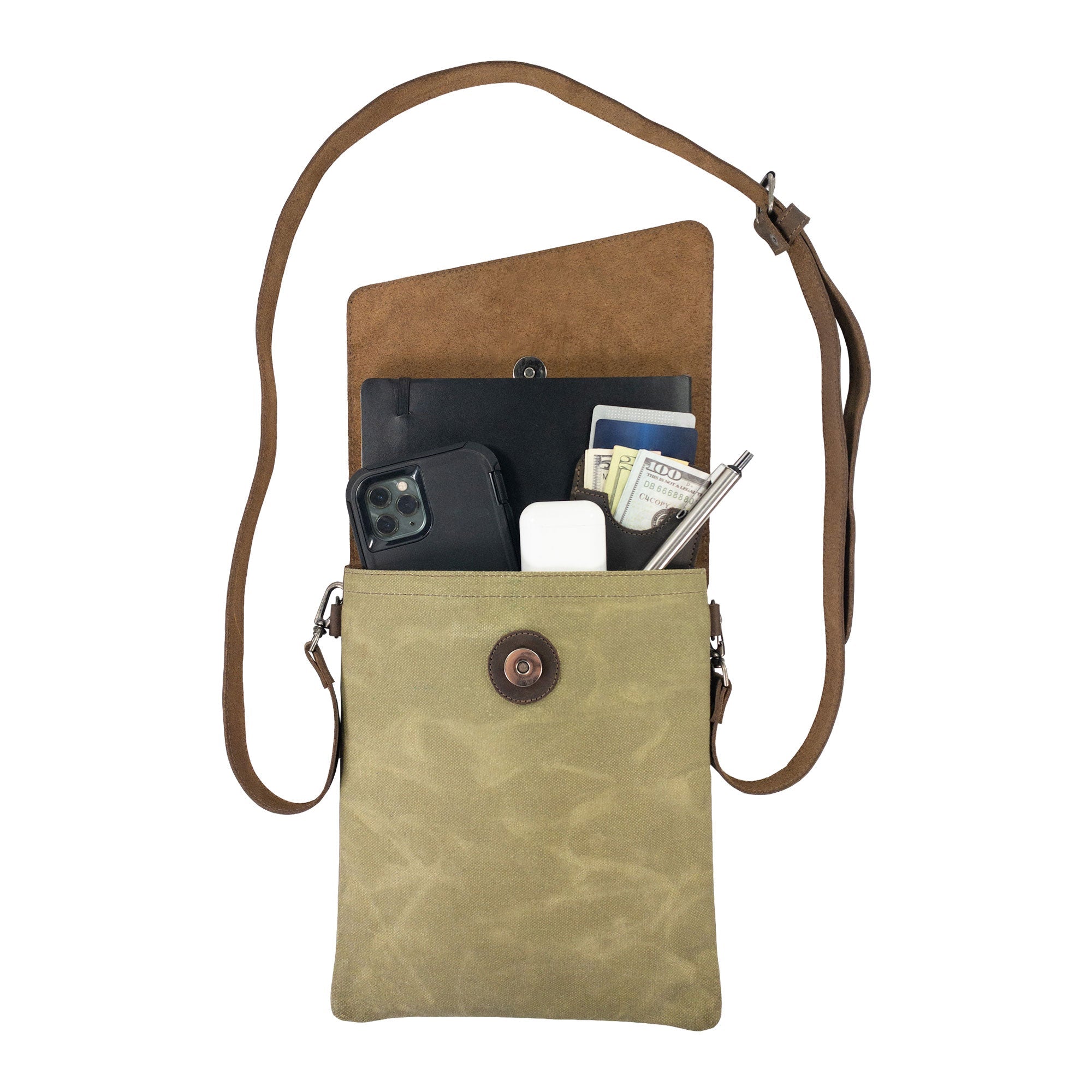 Hide & Drink Crossbody Bag featuring an open design with items inside including a phone, money, and a pen. This Crossbody Bag with Adjustable Shoulder Strap is a Unisex Messenger Bag crafted from Full Grain Leather & Waxed Canvas, showcasing small batch production, hand cut, hand sewn, fire branded craftsmanship by artisans in La Antigua Guatemala & Oaxaca Mexico.