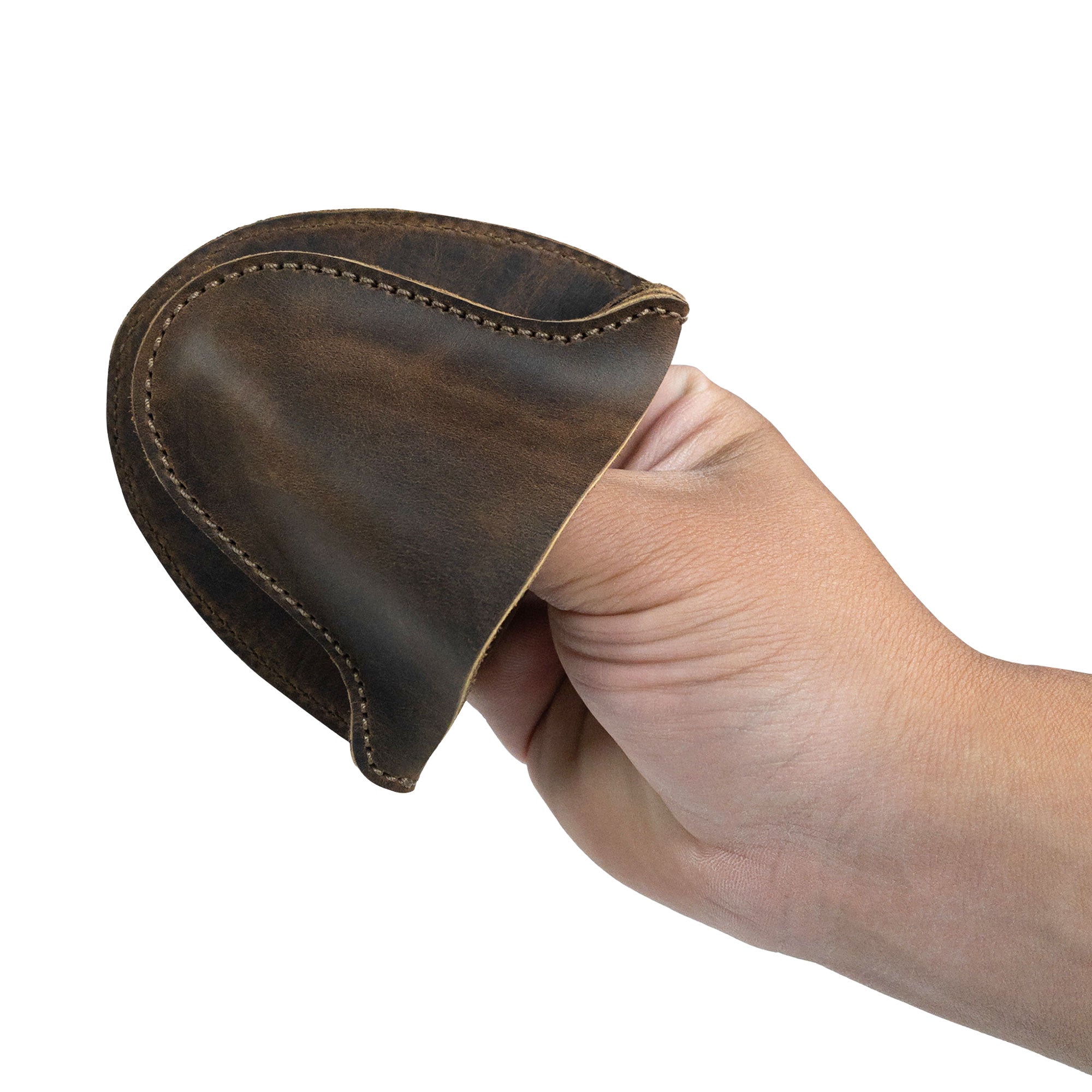 A hand gripping the Oven Mitt Heat Resistant from Cast Leather Co., showcasing its stylish and durable full grain leather, perfect as a rustic potholder for kitchen cooking and baking. This oven glove is handcrafted in La Antigua Guatemala, ensuring quality with small batch production, hand cut, hand sewn, and fire branded workmanship. Ideal for preventing burns while cooking.