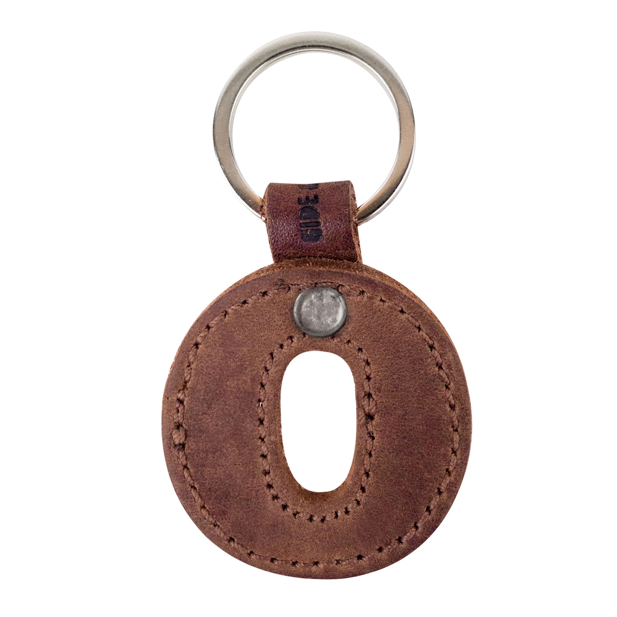 Close-up view of the letter O in thick leather Alphabet Letter Keychains by Hide & Drink. Made from Full Grain Leather, this artisanal keychain showcases small batch production and is hand cut, hand sewn, and fire branded, reflecting the craftsmanship from La Antigua Guatemala.