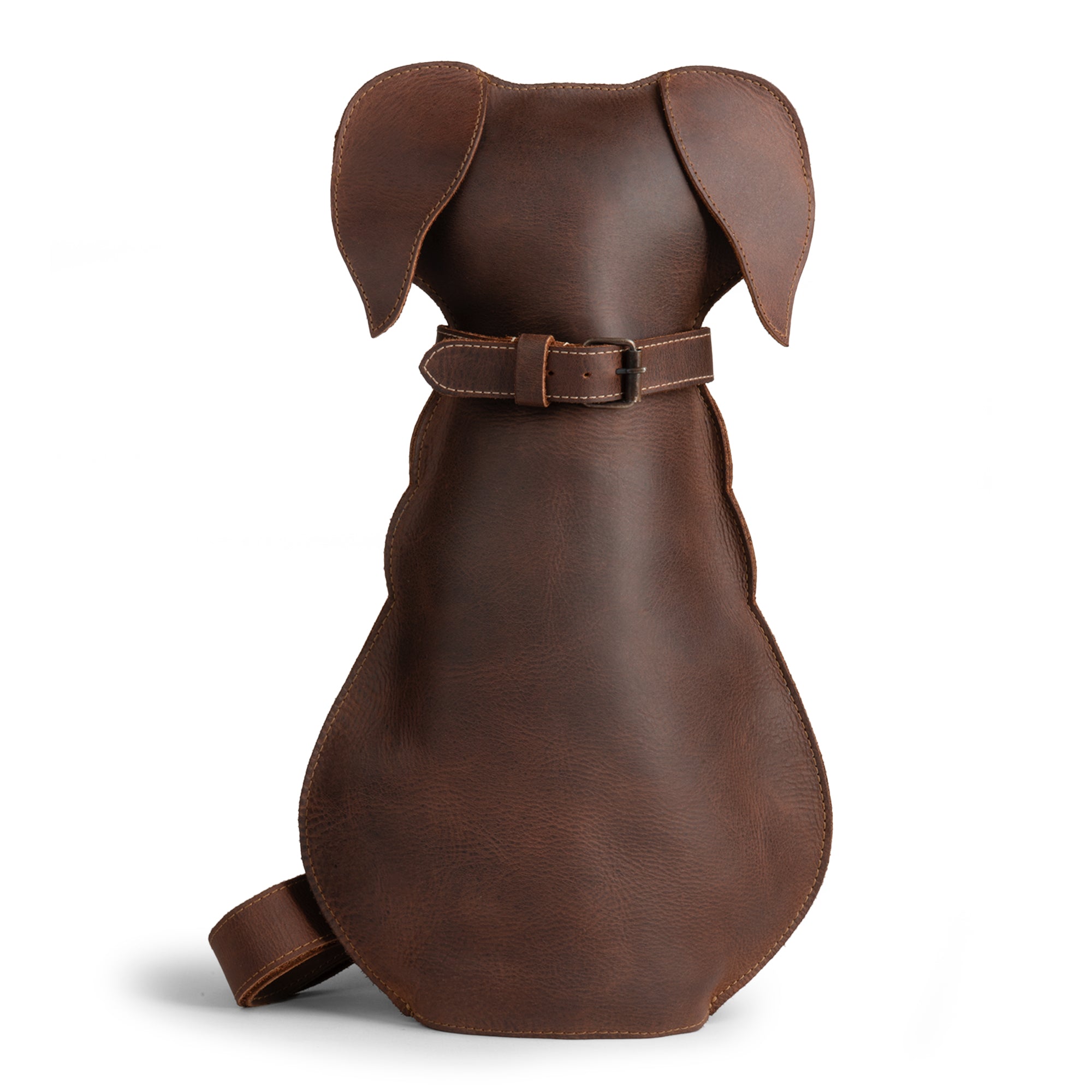 Back view of a Doggy-Shaped Backpack by Hide & Play, showcasing the full grain leather design with a belt detail. Ideal for pet lovers looking for a stylish accessory, this Dog-Shaped Backpack is a perfect travel companion. Crafted through small batch production, hand cut and sewn by artisans in La Antigua Guatemala, combining quality and tradition.