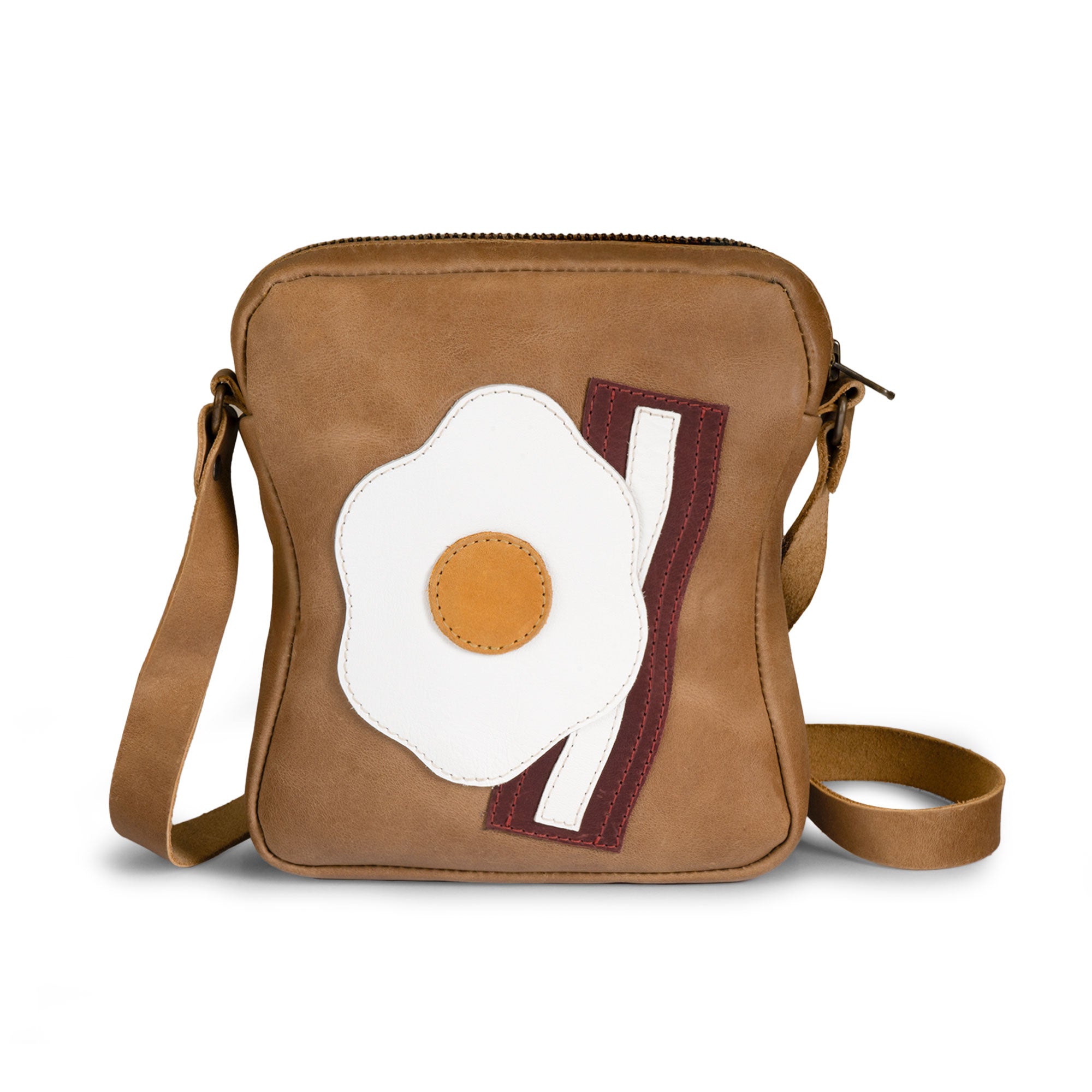 Stylish Egg and Bacon Sandwich-Shaped Shoulder Bag by Tudi Frudi, showcasing a unique design with an adjustable strap. Perfect as a Handbag, Crossbody Bag, or Messenger Bag, made from Full Grain Leather through Small Batch Production, Hand Cut, and Hand Sewn techniques. Artisan quality, Handmade in La Antigua Guatemala.