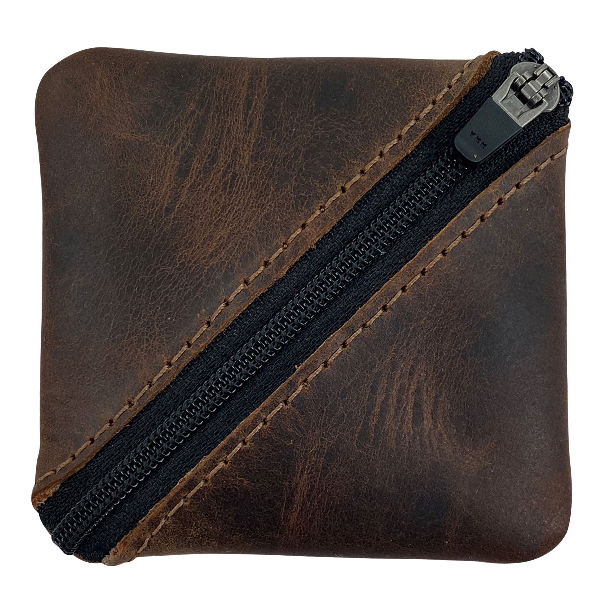 Slash Zippered Pouch by Hide & Drink, showcasing a durable full grain leather design with a stylish diagonal zipper. Ideal for change holder and storage, perfect for pocket and purse organization. Made in La Antigua Guatemala and Oaxaca Mexico with artisan craftsmanship.