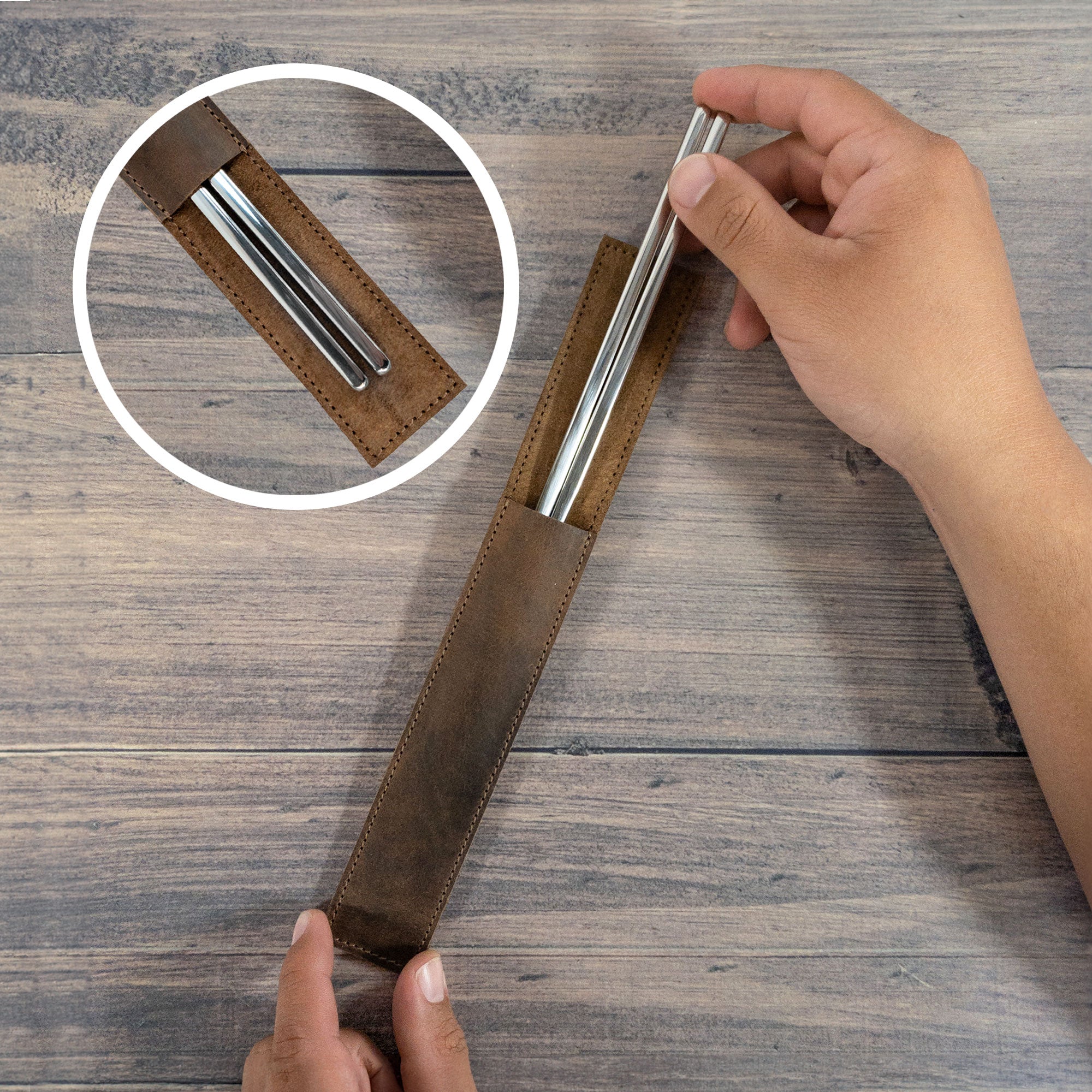 User demonstrating the practical use of the Set of 2 Rectangular Chopstick Holders from Cast Leather Co. These full grain leather sleeves offer stylish protection for bamboo wooden Chinese chopsticks, reflecting handmade craftsmanship in every detail.