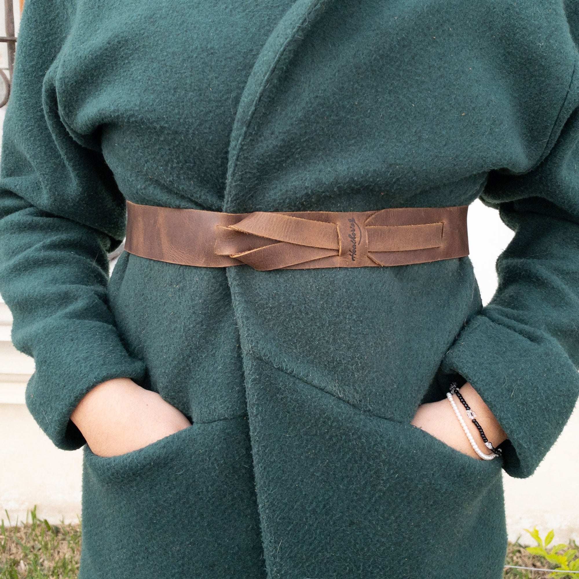 Heather's Fashion Belt for Women showcased on a model, this no-buckle waist strap is made from soft full grain leather. An ideal accessory for layering in autumn and winter, it is handcrafted in La Antigua Guatemala. Fashion Belt for Women without Buckle, No-Buckle Belt, Stylish Belly Accessory, Small Batch Production, Hand Cut, Hand Sewn, Fire Branded, Artisan.