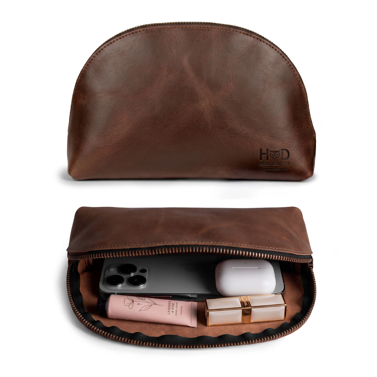 Inside view of the Accessory Pouch Organizer Hand Bag by Hide & Drink, filled with cosmetics. This artistic Cosmetic Travel Organizer with Hand Strap for Women is the perfect Makeup Bag or Classic Handbag crafted from durable full grain leather. Handmade and fire branded, it embodies artisan craftsmanship from La Antigua Guatemala & Oaxaca Mexico.