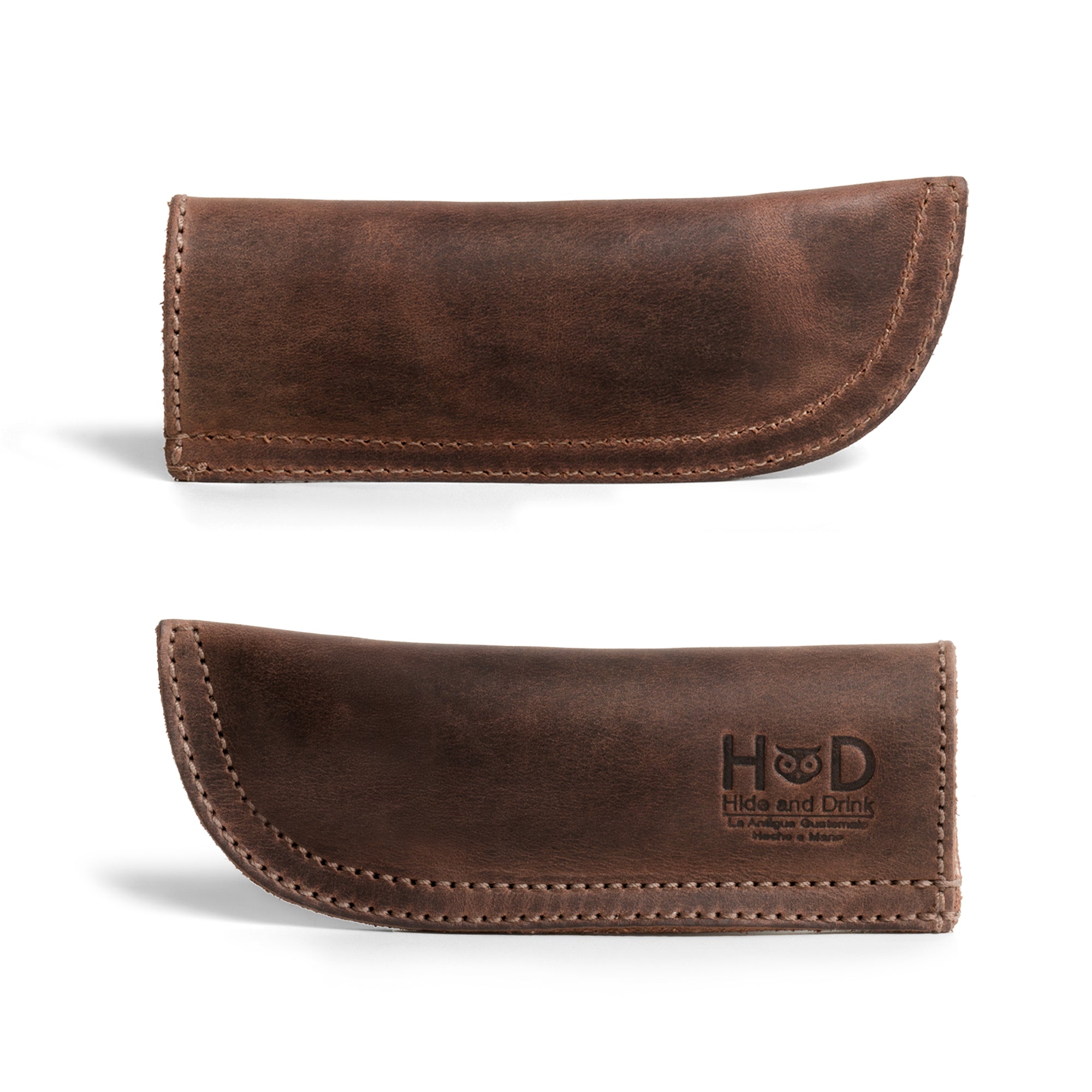 Hide & Drink Cast Iron Panhandle Cover displayed in a stylish design, made from durable full grain leather. This artisan hot handle protector offers optimal safety and convenience, featuring double layered construction for heat resistance. Hand cut and sewn in La Antigua Guatemala & Oaxaca Mexico, it's an essential kitchen accessory.