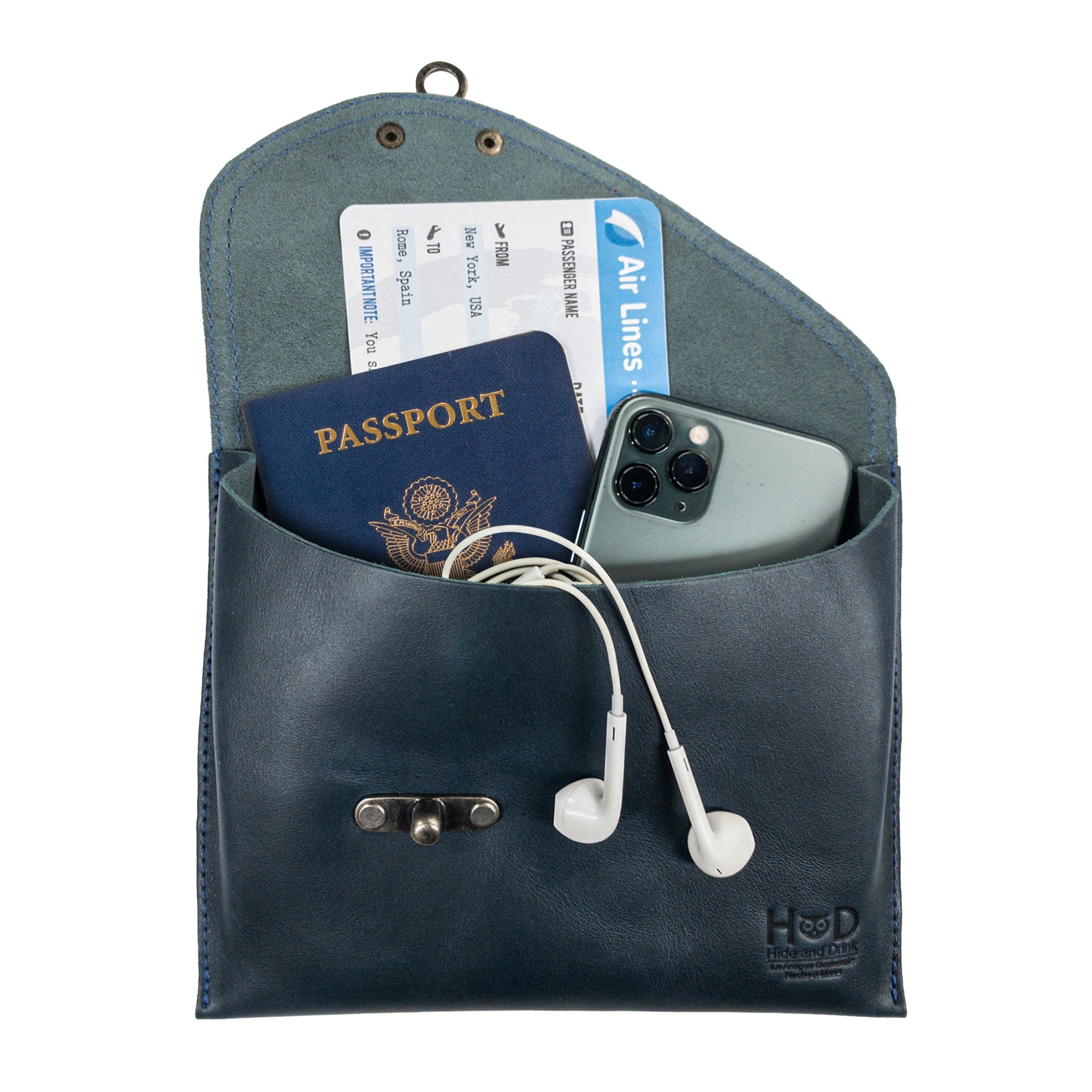 Filled with essentials, the navy Petite Vintage Clutch Bag by Hide & Drink demonstrates its functionality. A stylish evening bag made from full grain leather, this chic travel accessory is perfect for daily use, showcasing handmade craftsmanship in La Antigua Guatemala & Oaxaca Mexico.