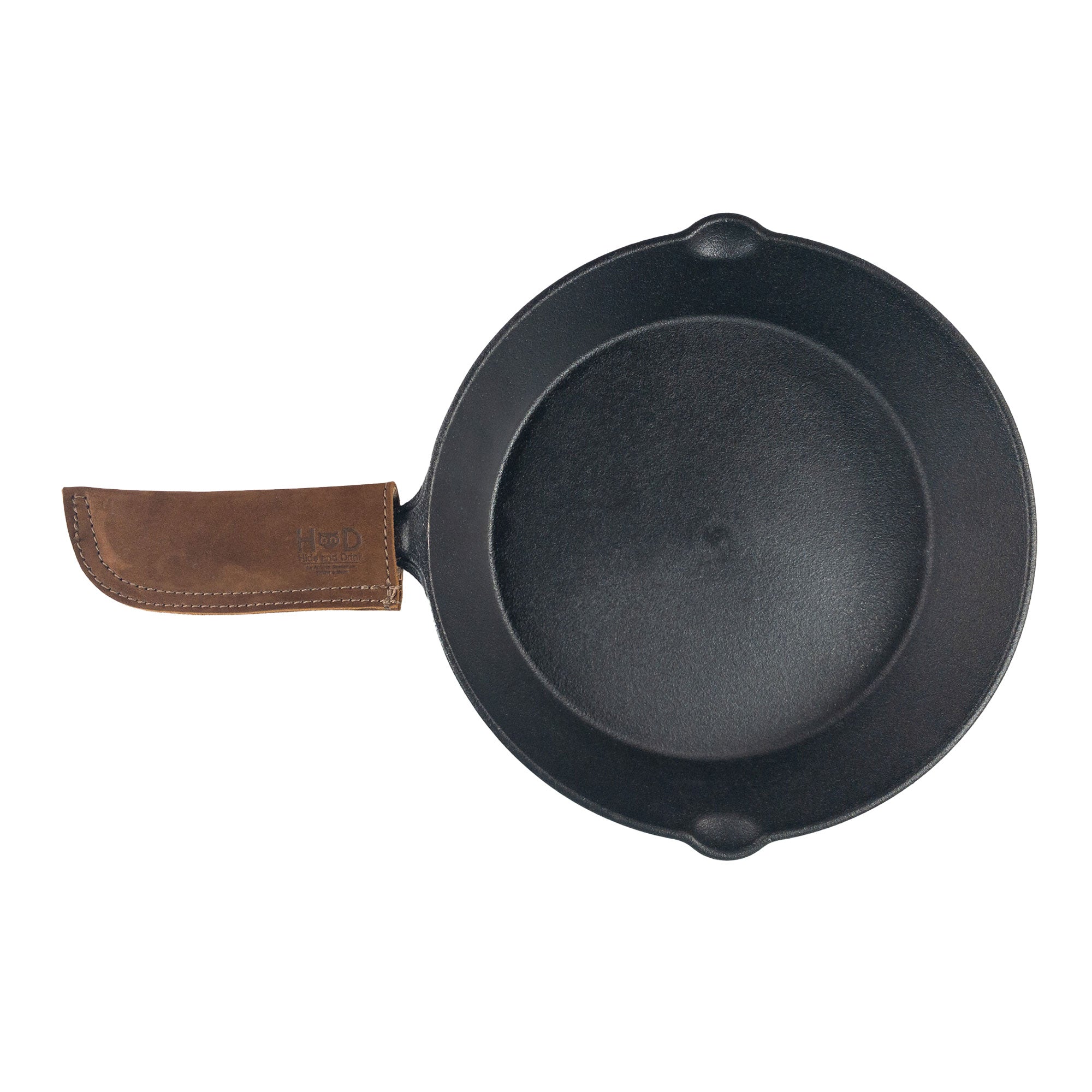 Hide & Drink Cast Iron Panhandle Cover elegantly showcasing its design on a skillet. This double stitched artisan pot holder offers heat protection and comfort, making it an essential kitchen accessory. Crafted in La Antigua Guatemala & Oaxaca Mexico from full grain leather, it’s a testament to skill and artistry.