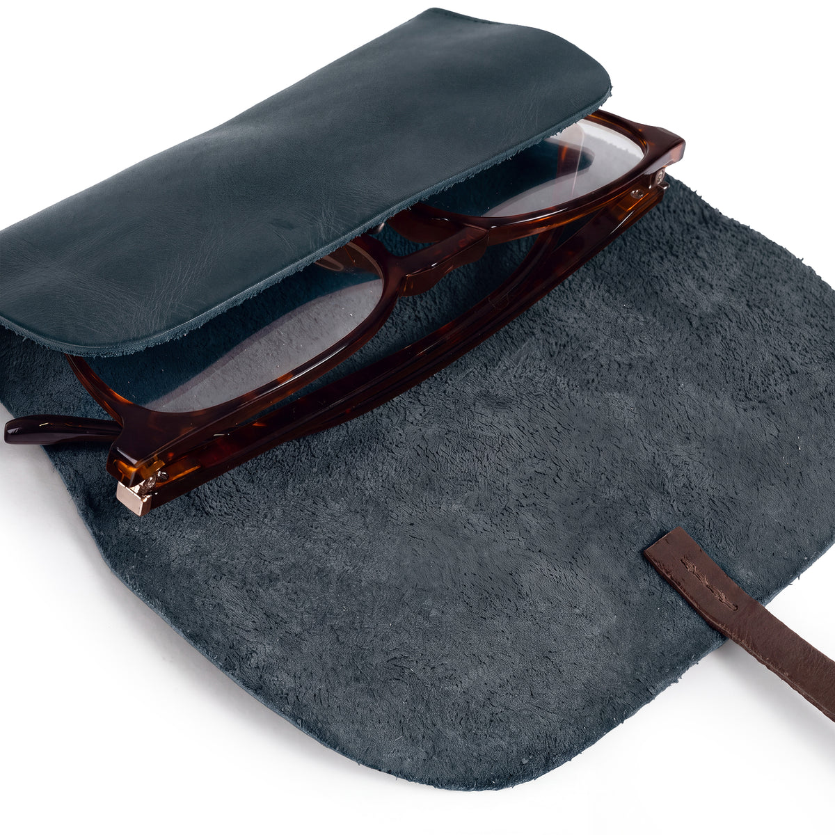 Hide & Drink Sunglass Wrap features a chic leather design that safely stores sunglasses. This eye glasses storage solution, made with full grain leather, is ideal for travel and reflects the artistry of small batch production.