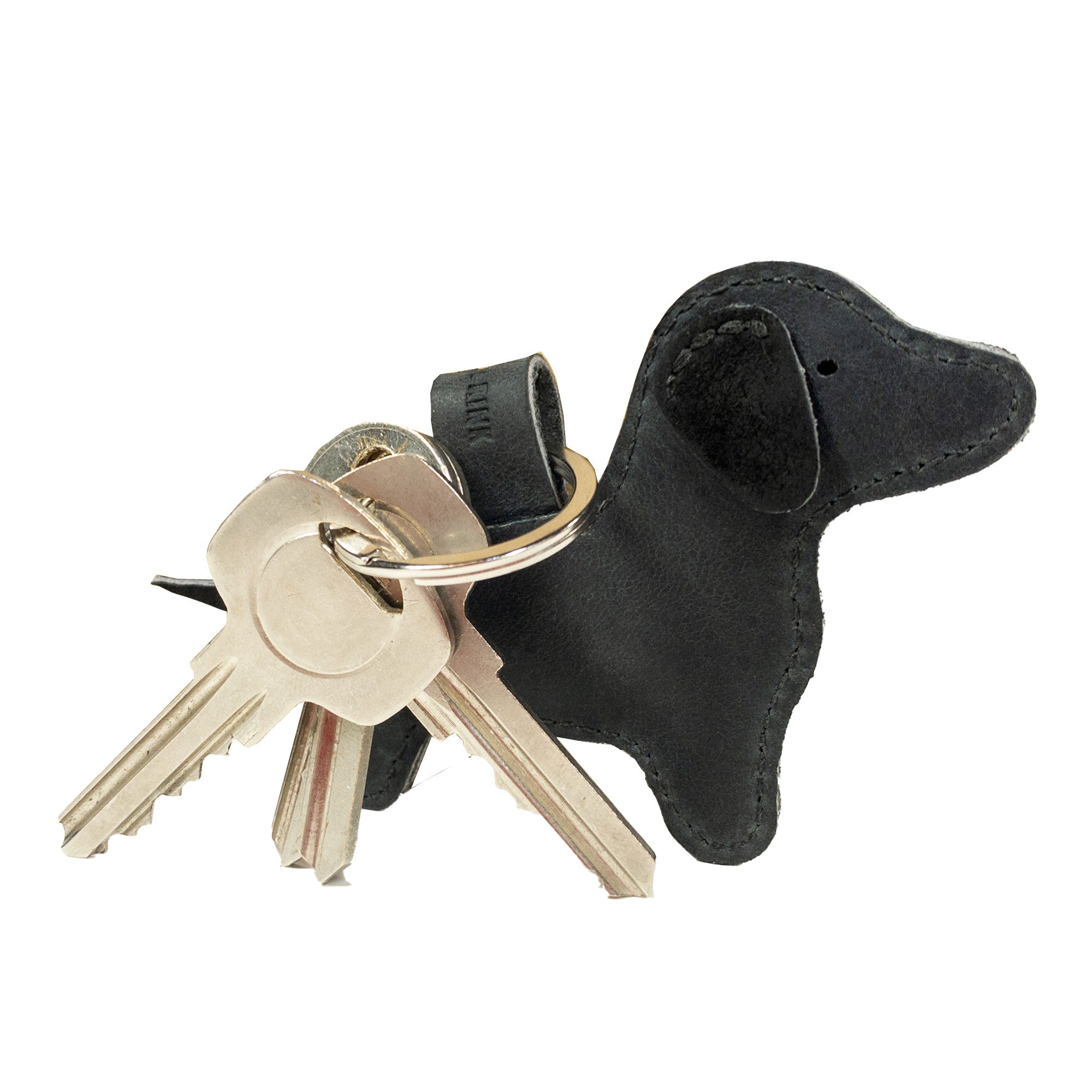 Highlighting the Hide & Drink Dog Keychain in black leather, this image showcases its elegant design as a fashionable Dachshund Keyring. Each piece is meticulously handcrafted from Full Grain Leather, demonstrating the brand's commitment to artisan quality, made in La Antigua Guatemala & Oaxaca Mexico.