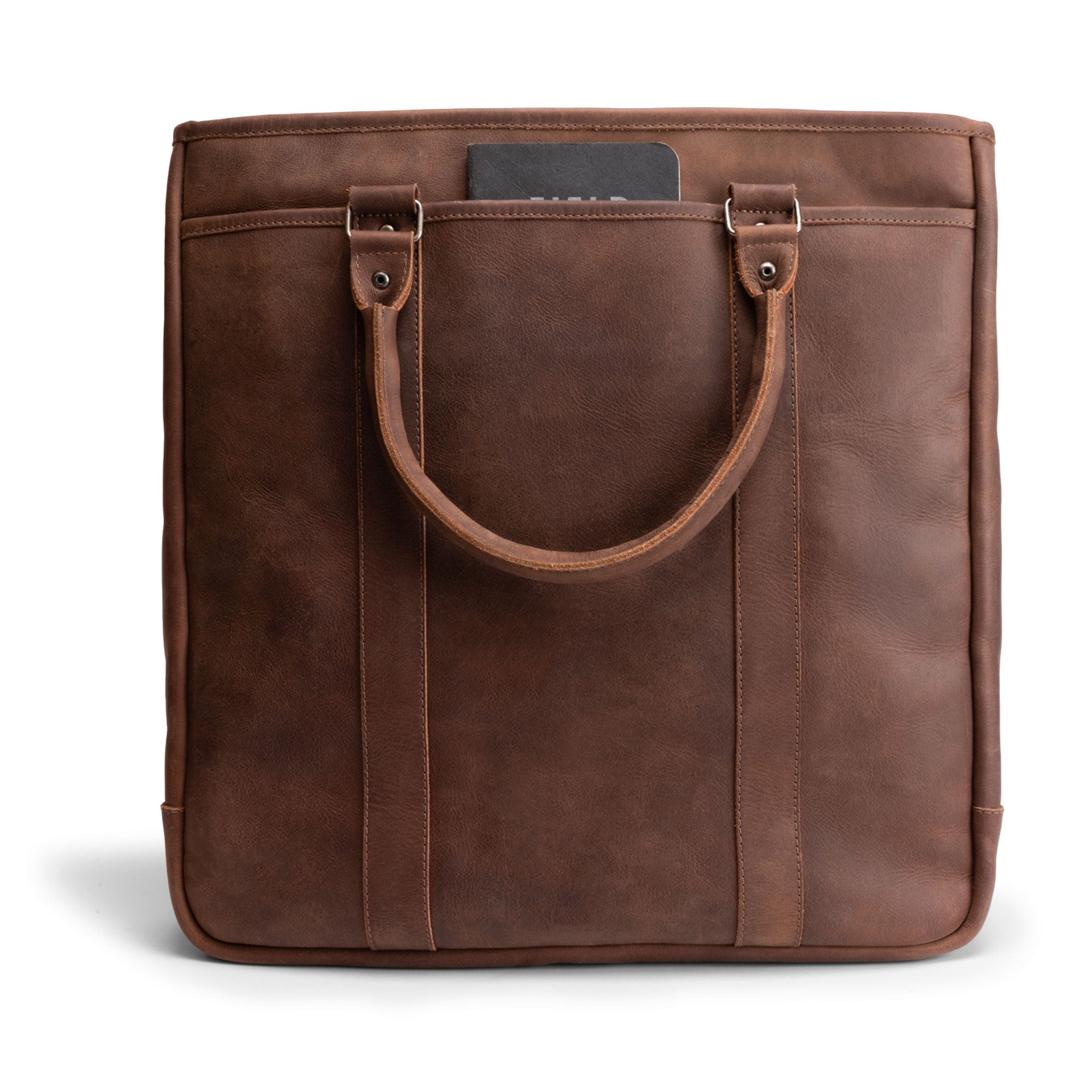 Back view of Littlefield & Co. Vintage Tote Vertical Briefcase & Laptop Carrier, emphasizing its sleek design and full grain leather finish. Ideal for easy access during work and weekend getaways, this artisan-built briefcase reflects craftsmanship with hand cut and hand sewn details. Perfect for stylish professionals seeking quality and durability.