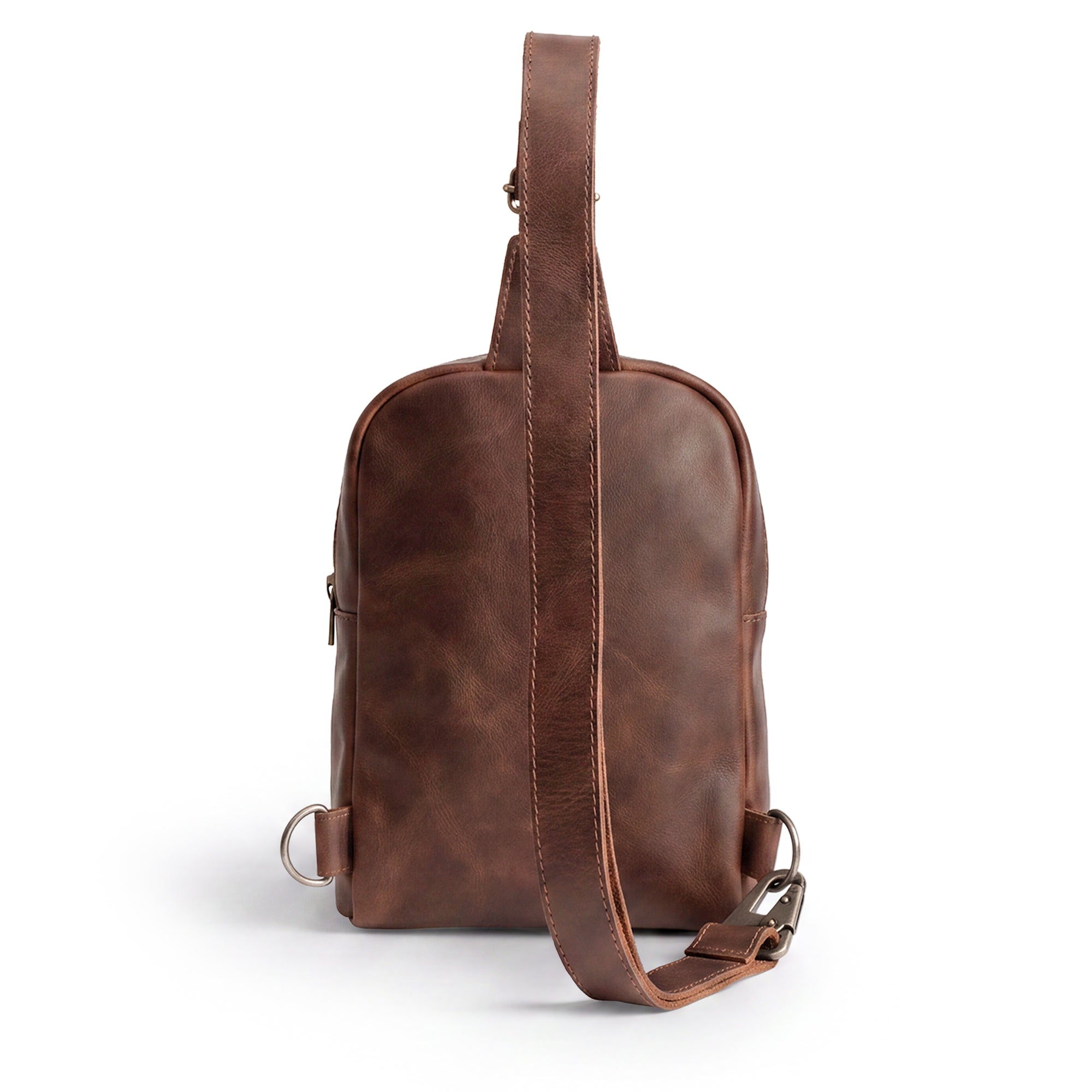 Different views of the Hide & Drink Crossbody Rounded Bag, showcasing left and right attachments. This versatile Rounded Crossbody Bag with Adjustable Strap offers practicality and style, crafted from Full Grain Leather with a focus on small batch artisan production from La Antigua Guatemala & Oaxaca Mexico.