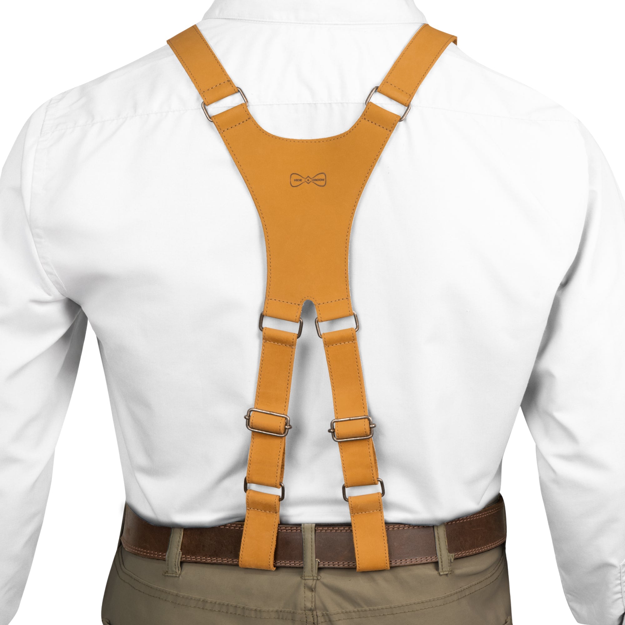Back view of yellow X Back Formal Suspenders by Hide & Groom, highlighting their thoughtful design in full grain leather. Perfect wedding accessories, they offer excellent shoulder support for grooms. Each item showcases the craftsmanship of artisans in La Antigua Guatemala, being handmade and carefully produced in small batches.