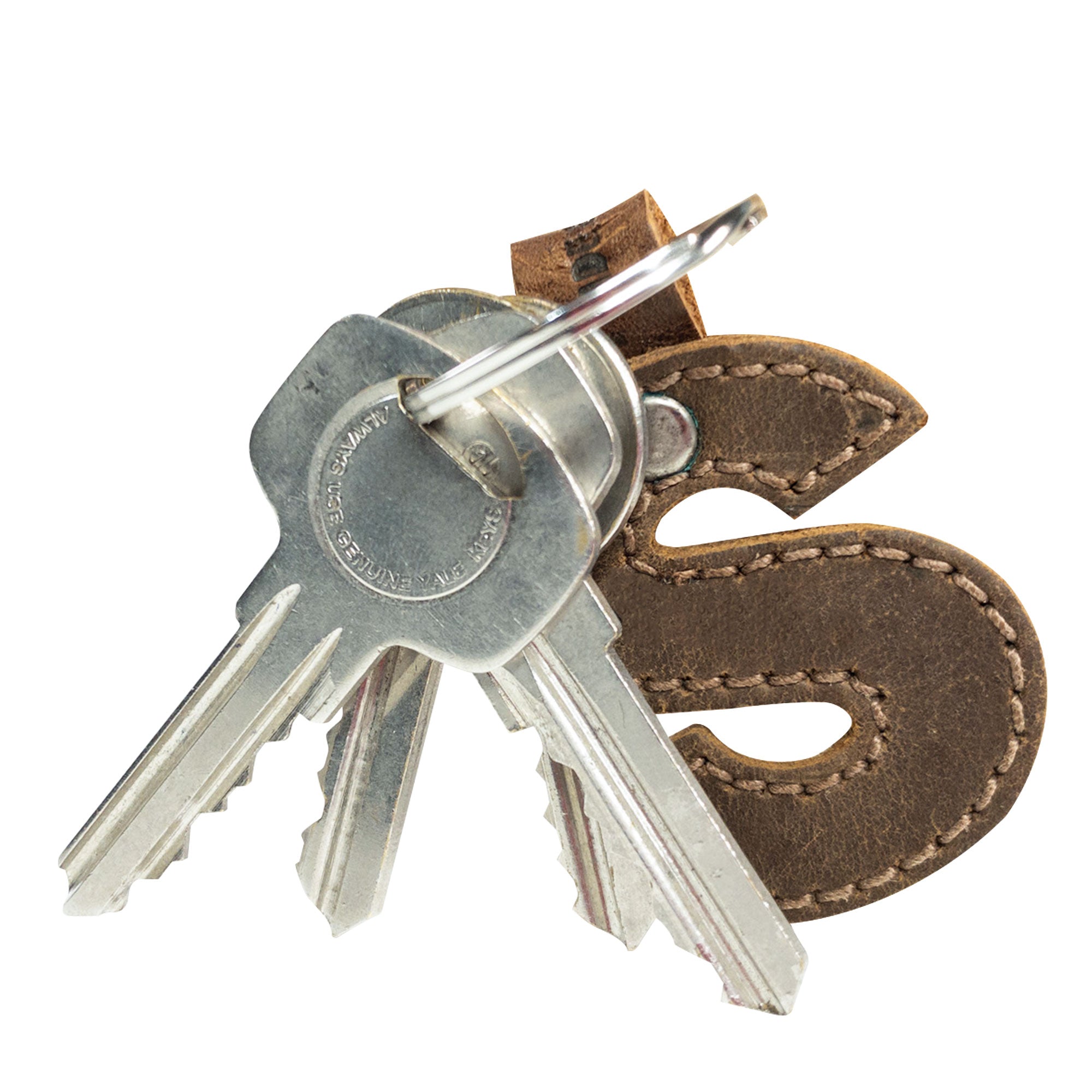 Side view of letter S in a leather keychain by Hide & Drink. This durable Alphabet Letter Keychain crafted from Full Grain Leather is an example of the small batch artisan methods from La Antigua Guatemala.