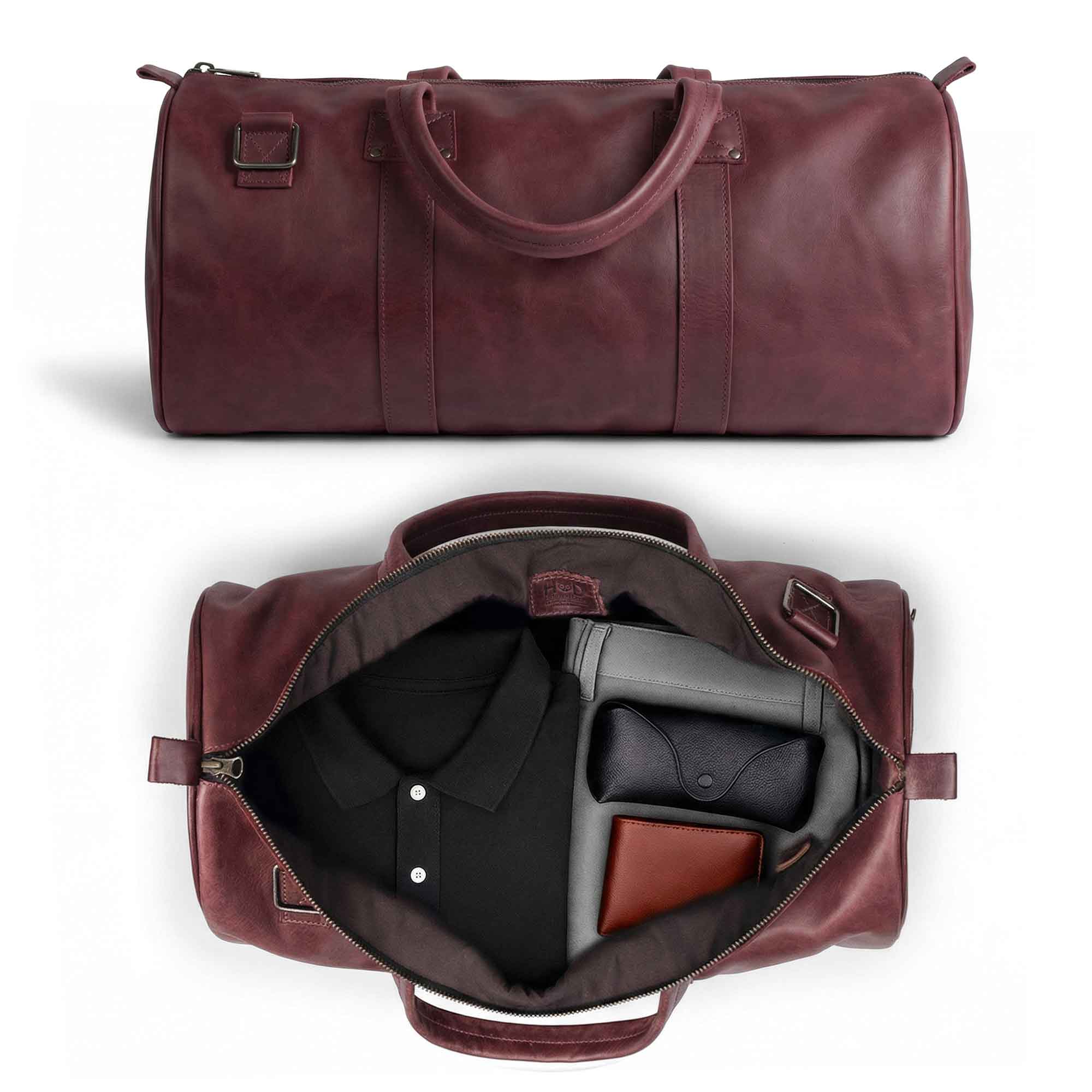 Top view of the Classic Duffle Bag by Hide & Drink in pink leather, showcasing its roomy interior and adjustable strap with zipper closure. This Full Grain Leather Classic Duffle Bag acts as a beautiful Messenger Bag for traveling needs, handcrafted in La Antigua Guatemala & Oaxaca Mexico.