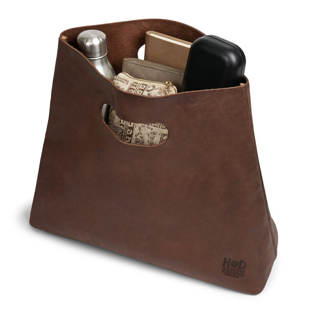 Close-up view of the Hide & Drink Minimalist Boho Handbag highlighting its sturdy Full Grain Leather construction. This artisan-made rustic purse is perfect for shopping or daily use, showcasing small batch production from La Antigua Guatemala & Oaxaca Mexico.