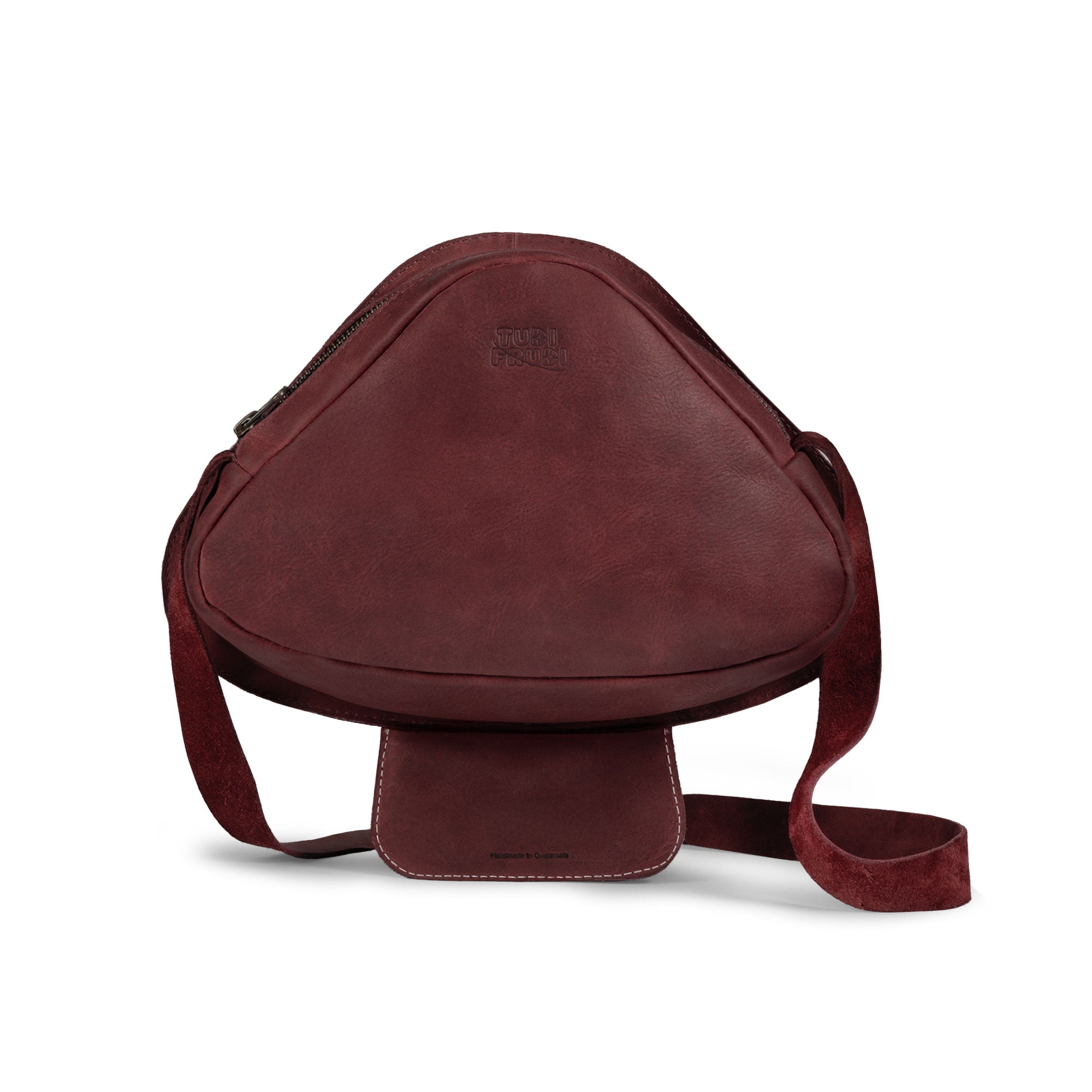 Mushroom-Shaped Leather Shoulder Bag by Tudi Frudi, featuring a whimsical design with an adjustable strap. This versatile crossbody bag is perfect for travel or as a messenger bag, crafted from Full Grain Leather, showcasing stockyardX's small batch production. Hand cut and sewn for quality, this artisan bag is handmade in La Antigua Guatemala.