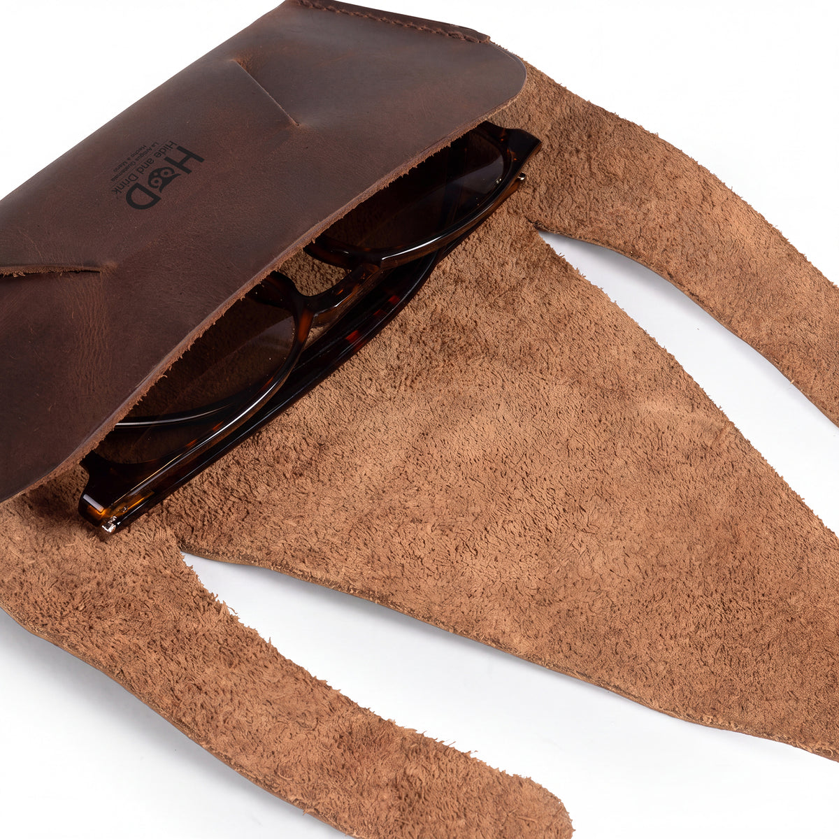 Inside view of the Foldable Sunglass Case by Hide & Drink, designed to fit sunglasses snugly. Made from Full Grain Leather, this artisan accessory is hand cut and fire branded, reflecting its handmade origins in La Antigua Guatemala and Oaxaca, Mexico.