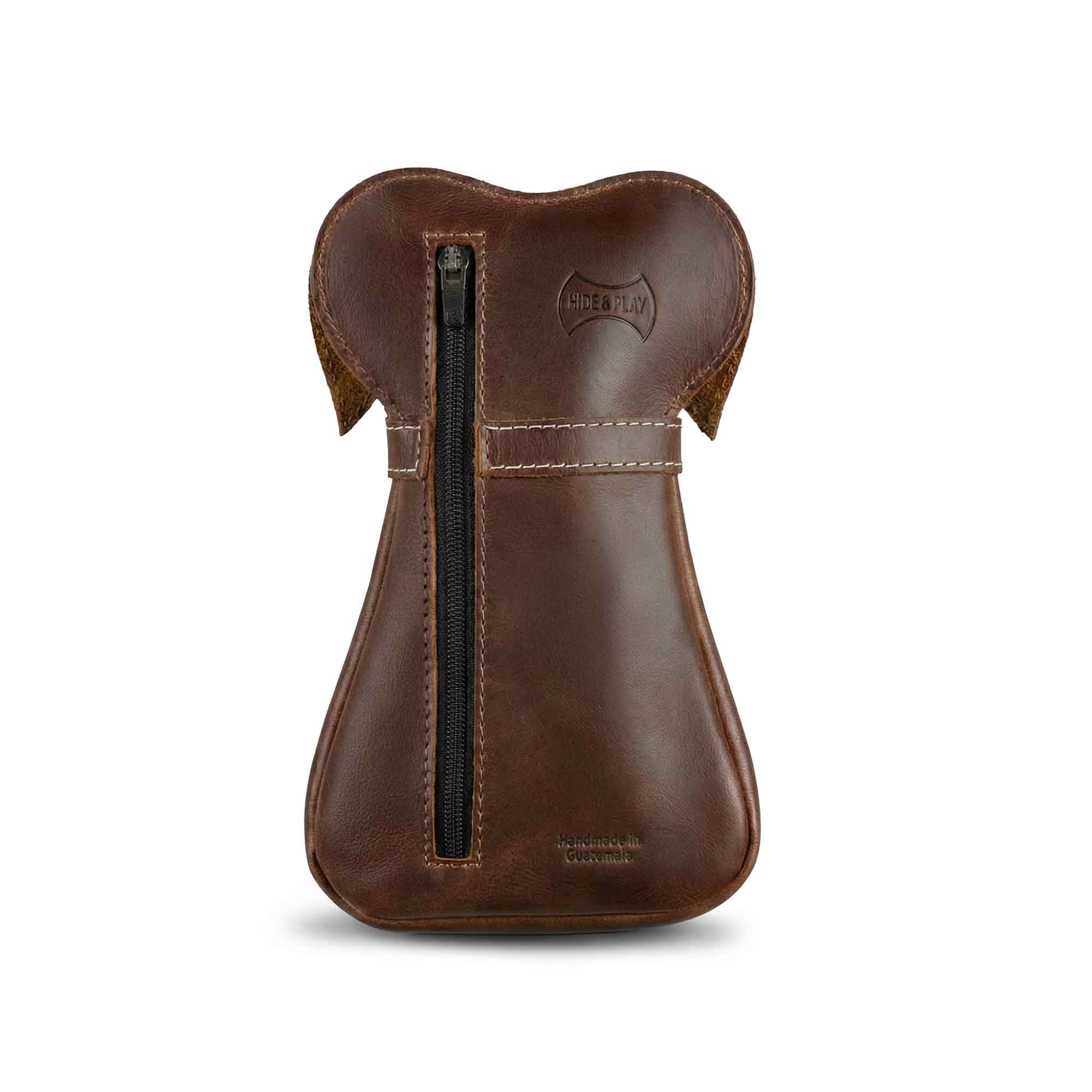 Leather Doggy Pouch by Hide & Play in use, highlighting a person holding the leather pouch as a Cash Holder Organizer. This versatile Leather Doggy-Shaped Coin Pouch Piggy Bank, made from Full Grain Leather, serves as a stylish Coin Purse for Men & Women and a perfect Money Saving Box. This Small Mens Wallet for Coins features hand cut and hand sewn quality, made with love in La Antigua Guatemala and Oaxaca Mexico.