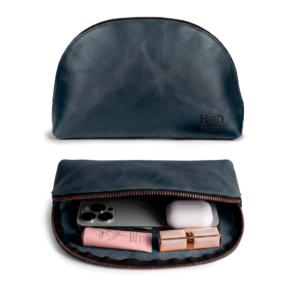 Inside view of the Accessory Pouch Organizer Hand Bag from Hide & Drink, filled with cosmetics and essentials. This Cosmetic Travel Organizer with Hand Strap for Women serves as an efficient Makeup Bag and Classic Handbag, handcrafted in small batches from La Antigua Guatemala & Oaxaca Mexico.