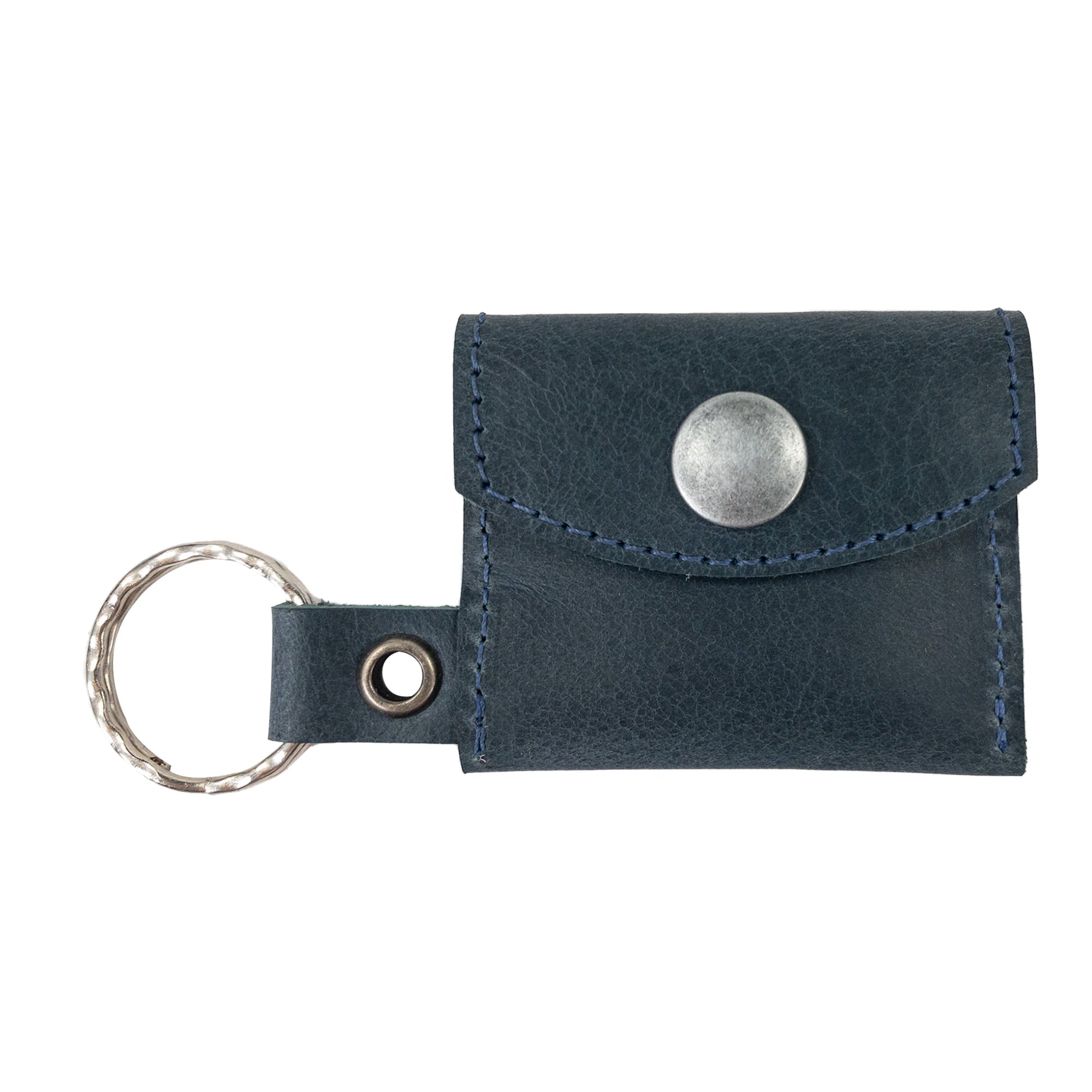 A beautiful arrangement featuring the Tiny Coin Holder Keychain by Hide & Drink. Constructed from premium Full Grain Leather, this Tiny Coin Holder is a mark of small batch artisan craftsmanship.