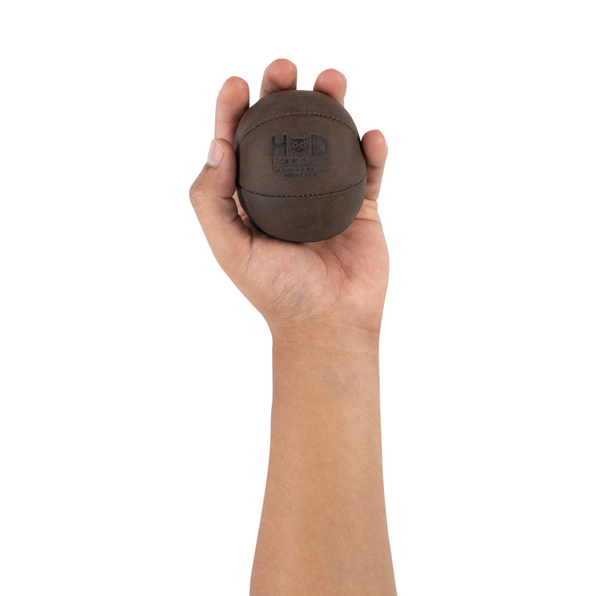Hide & Drink Stress Ball held in a hand, an ideal way to relieve fidgeting and anxiety. This squishy tension accessory is great for the office, showcasing a classic style with full grain leather. Artisan crafted in La Antigua Guatemala.