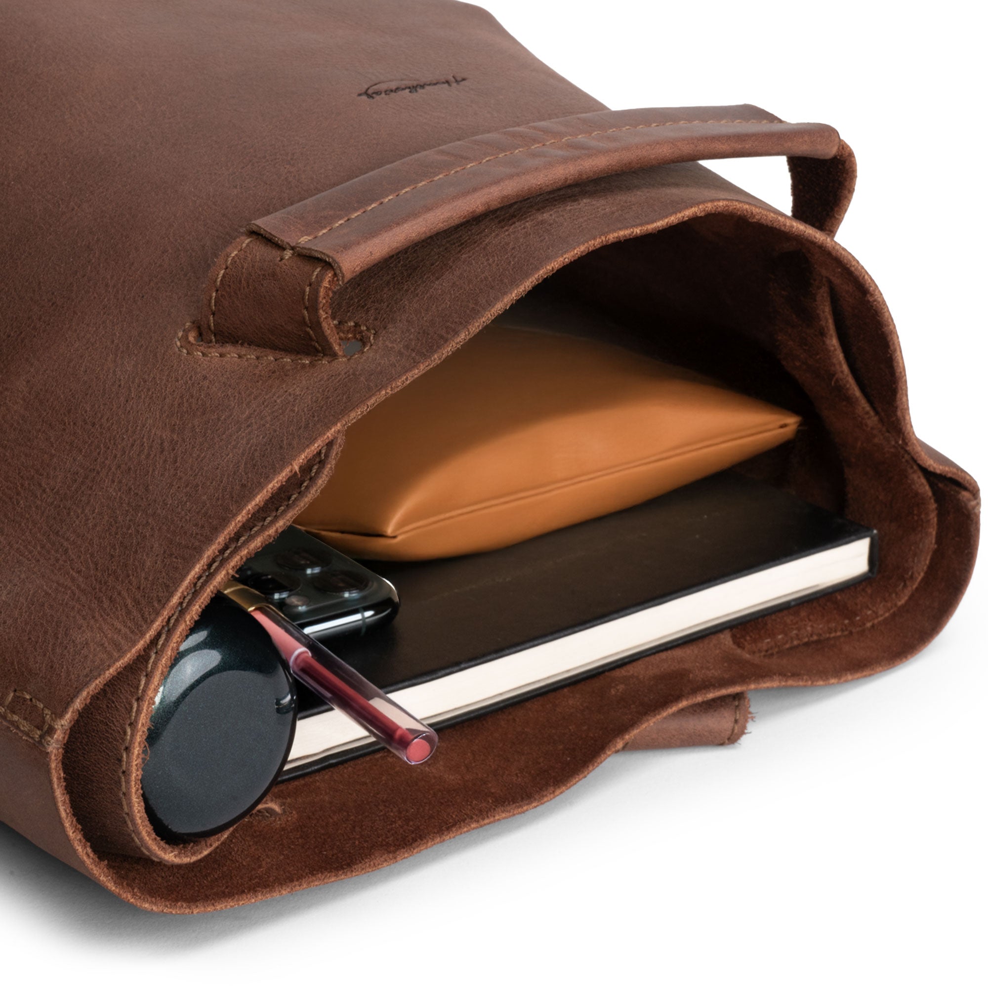 Interior view of Heather's Convertible Backpack to Shoulder Bag, showcasing its ample space for essentials. Made from Full Grain Leather, this handcrafted bag transitions easily from a squared purse to a crossbody, exemplifying Heather's artisan craftsmanship from La Antigua Guatemala & Oaxaca Mexico.