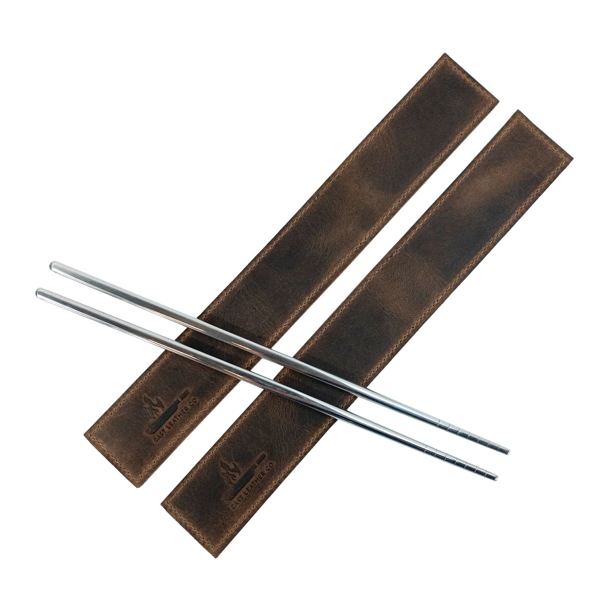 Chopsticks elegantly displayed in the Set of 2 Rectangular Chopstick Holders by Cast Leather Co. Ideal for storing and organizing bamboo wooden Chinese chopsticks, these artisan leather sleeves are hand cut, hand sewn, and made in La Antigua Guatemala.