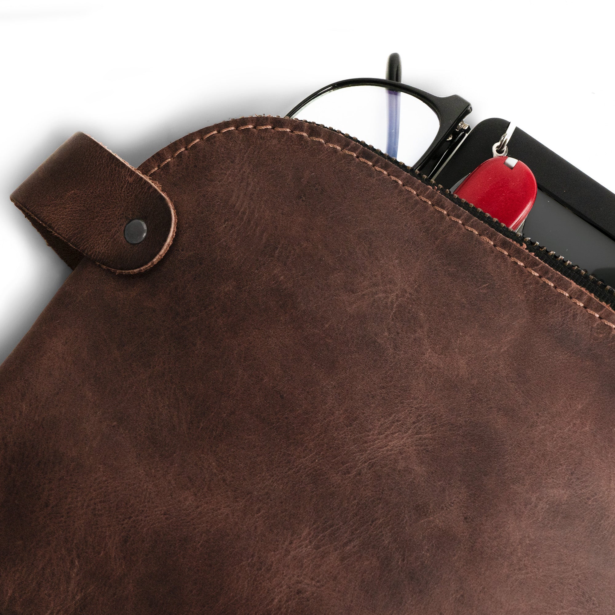 Close-up image of the Dopp Kit Utility Bag by Hide & Drink, showing its durable construction and elegant design as a small batch artisan piece. This large rustic all-purpose Dopp Kit Utility Bag is ideal for cords, chargers, and toiletries, made from full grain leather and crafted by hand in La Antigua Guatemala & Oaxaca Mexico.