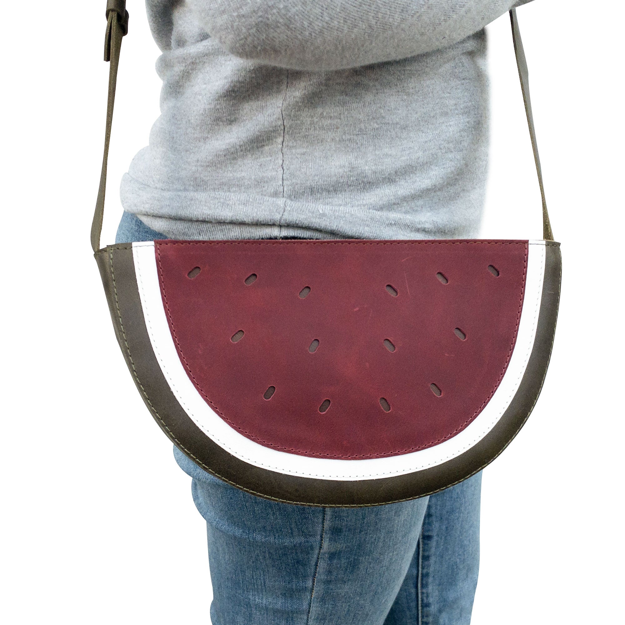 Woman wearing a Watermelon-Shaped Shoulder Bag by Tudi Frudi showcasing its stylish design and adjustable strap. This trendy Crossbody Bag and Messenger Bag is made from premium Full Grain Leather, emphasizing small batch production, hand cut, hand sewn, and fire branded artistry. Handmade in La Antigua Guatemala & Oaxaca Mexico.