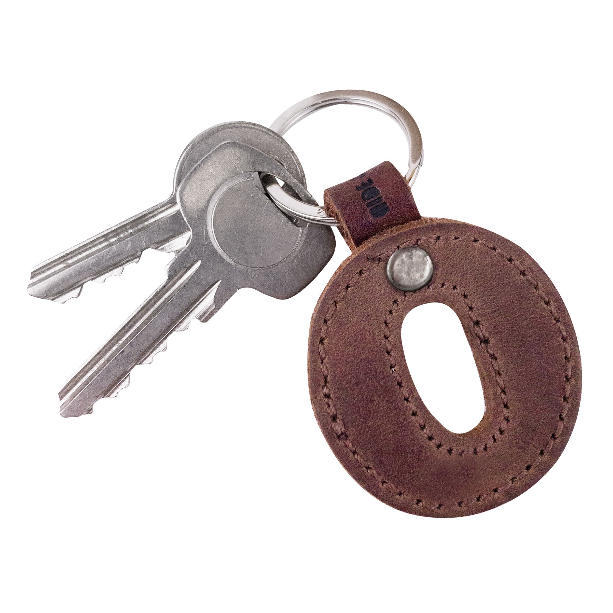 Detailed shot of the letter O in a leather keychain. This Alphabet Letter Keychain by Hide & Drink, made from Full Grain Leather, highlights small batch production with its hand cut and hand sewn design, embodying artisanal quality from La Antigua Guatemala.