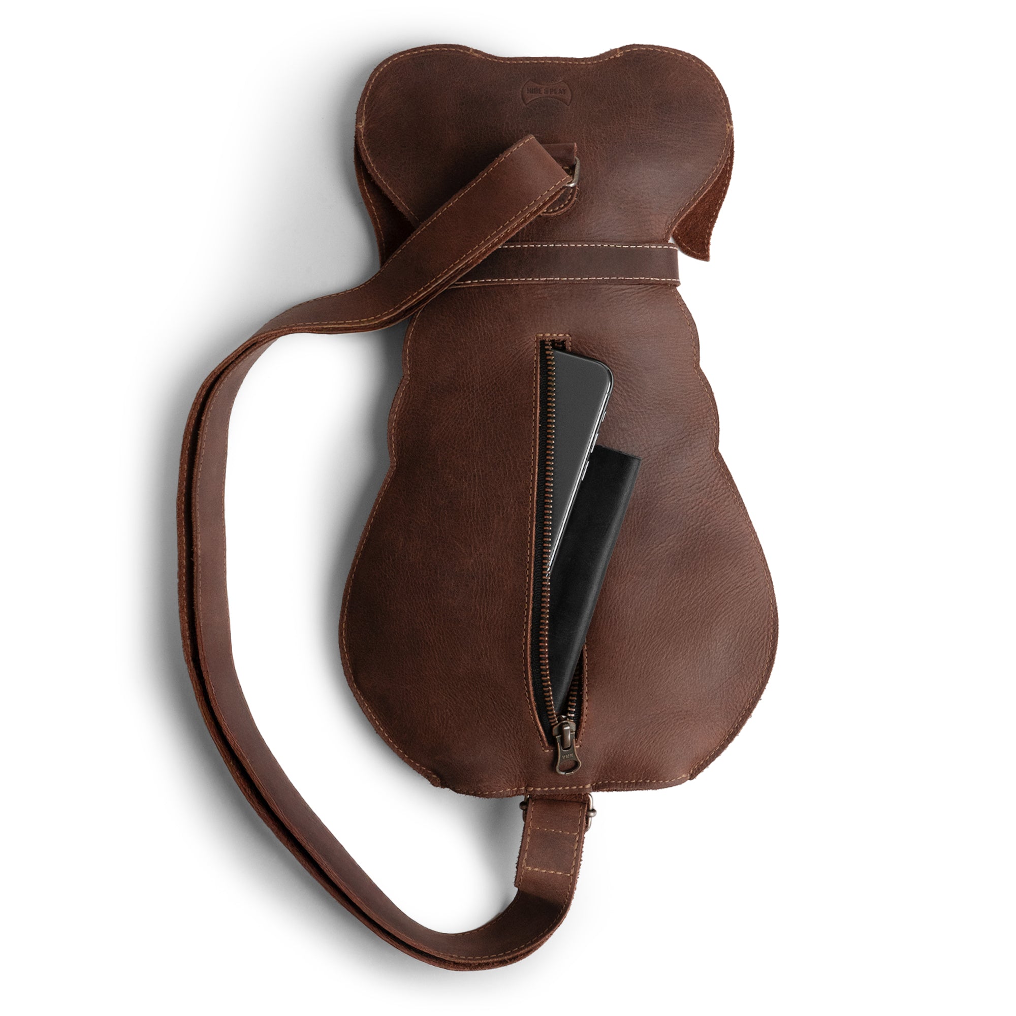Open view of the interior of a Doggy-Shaped Backpack by Hide & Play, highlighting the spacious zipper compartment. This crossbody bag is perfect for keeping essentials organized while showcasing the luxury of full grain leather. Each product is handmade by artisans in La Antigua Guatemala, ensuring unique quality and design.