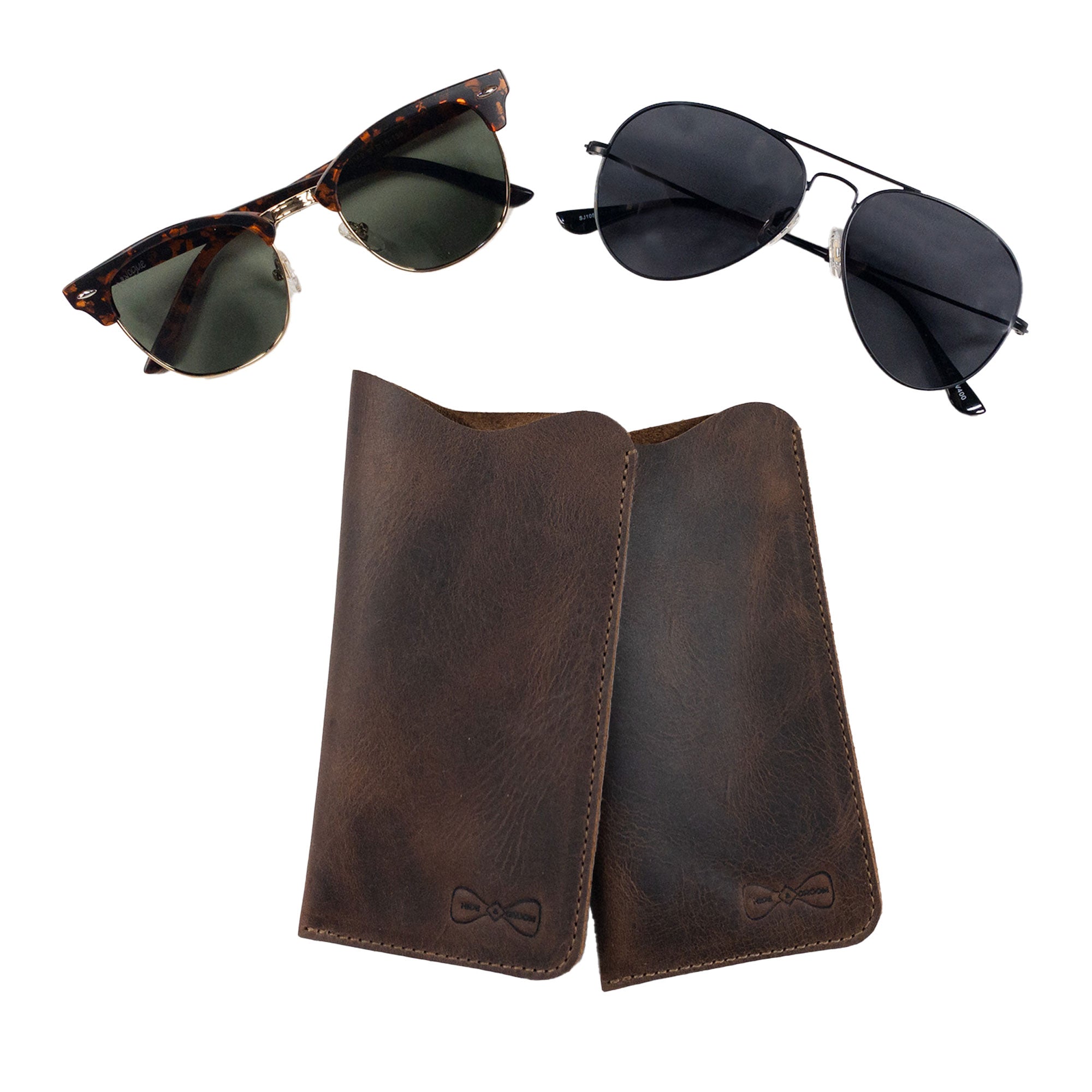 Hide & Groom Set of 2 Sunglasses Case with two stylish cases alongside sunglasses. This artisan-made product is perfect for men and women seeking reliable eyeglasses sleeves and safe storage for travel, showcasing high-quality full grain leather handcrafted in La Antigua Guatemala & Oaxaca Mexico.