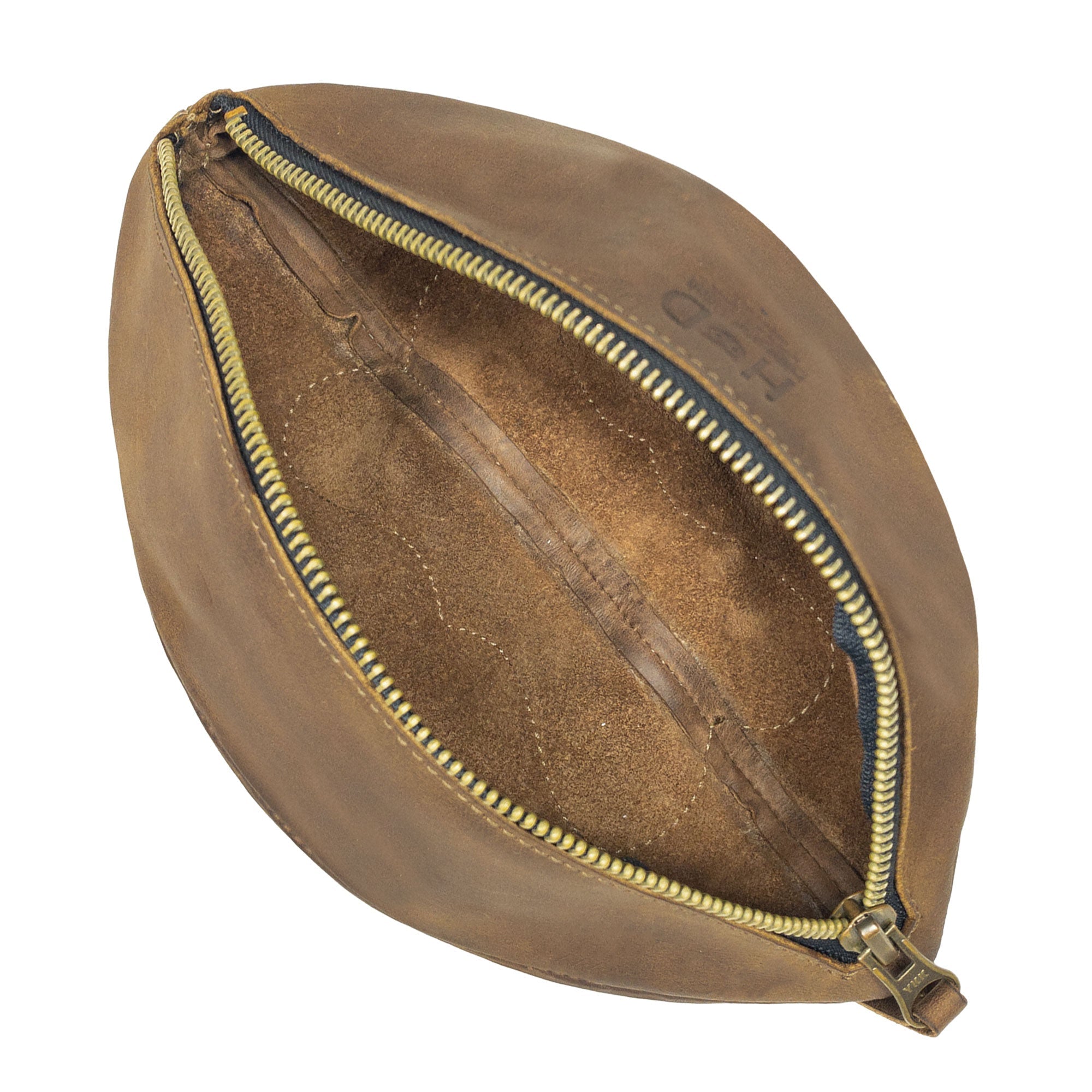 Interior of the Football Toiletry Bag by Hide & Drink, revealing its spacious design and durable full grain leather. This Gameday Football Dopp Toiletry Bag is perfect for travel organization, serving as a reliable bag for grooming essentials and shaving kit storage. Handmade in small batches, it highlights exceptional artisan work from La Antigua Guatemala.