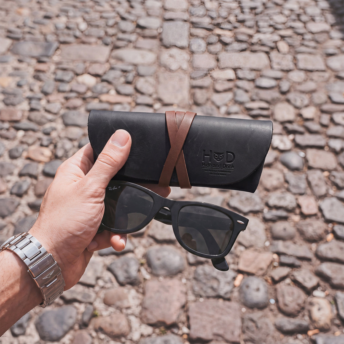 Hide & Drink Leather Sunglass Wrap is an elegant storage solution for sunglasses, made from soft full grain leather. This eye glasses storage option is perfect for travel, showcasing artisan craftsmanship and durability.
