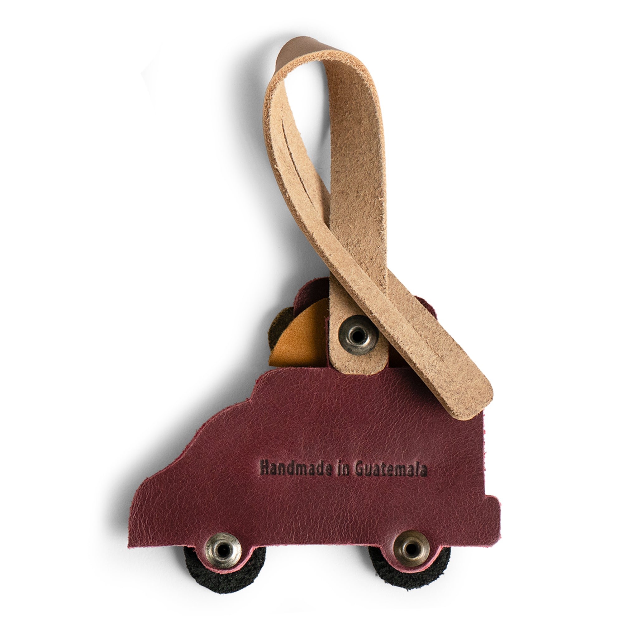 Bag Charms by Austin Genuine features a taco truck charm with a label 'Handmade in Guatemala.' This Austin Genuine Bag Charm showcases 7 unique designs made with full grain leather from StockyardX, crafted through small batch production, hand cut, hand sewn, and fire branded, artisan, handmade in La Antigua Guatemala & Oaxaca Mexico.