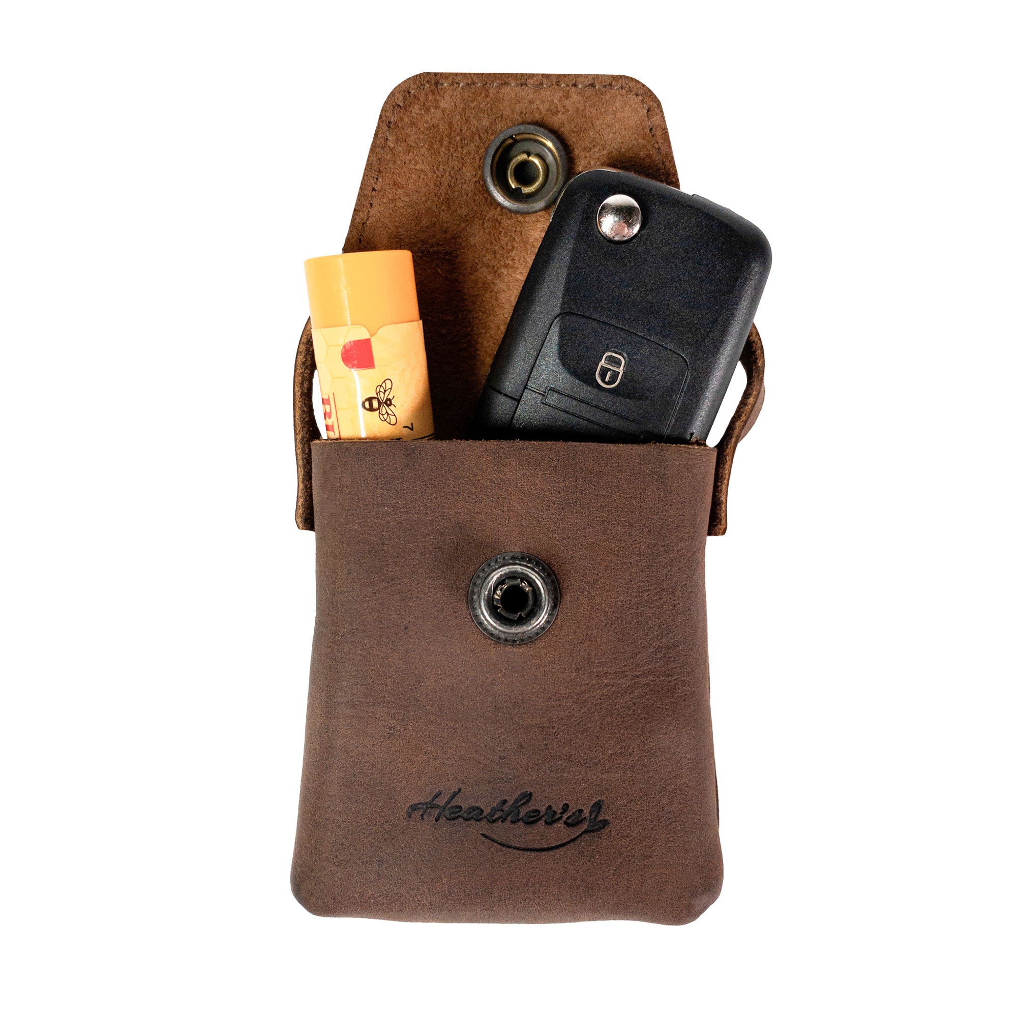 Inside view of Heather's Mini Purse-Shaped Keychain holding keys and essential items. This mini purse keychain for women is made from full grain leather, offering a vintage style keyring holder ideal for organization. Handmade in La Antigua Guatemala & Oaxaca Mexico.