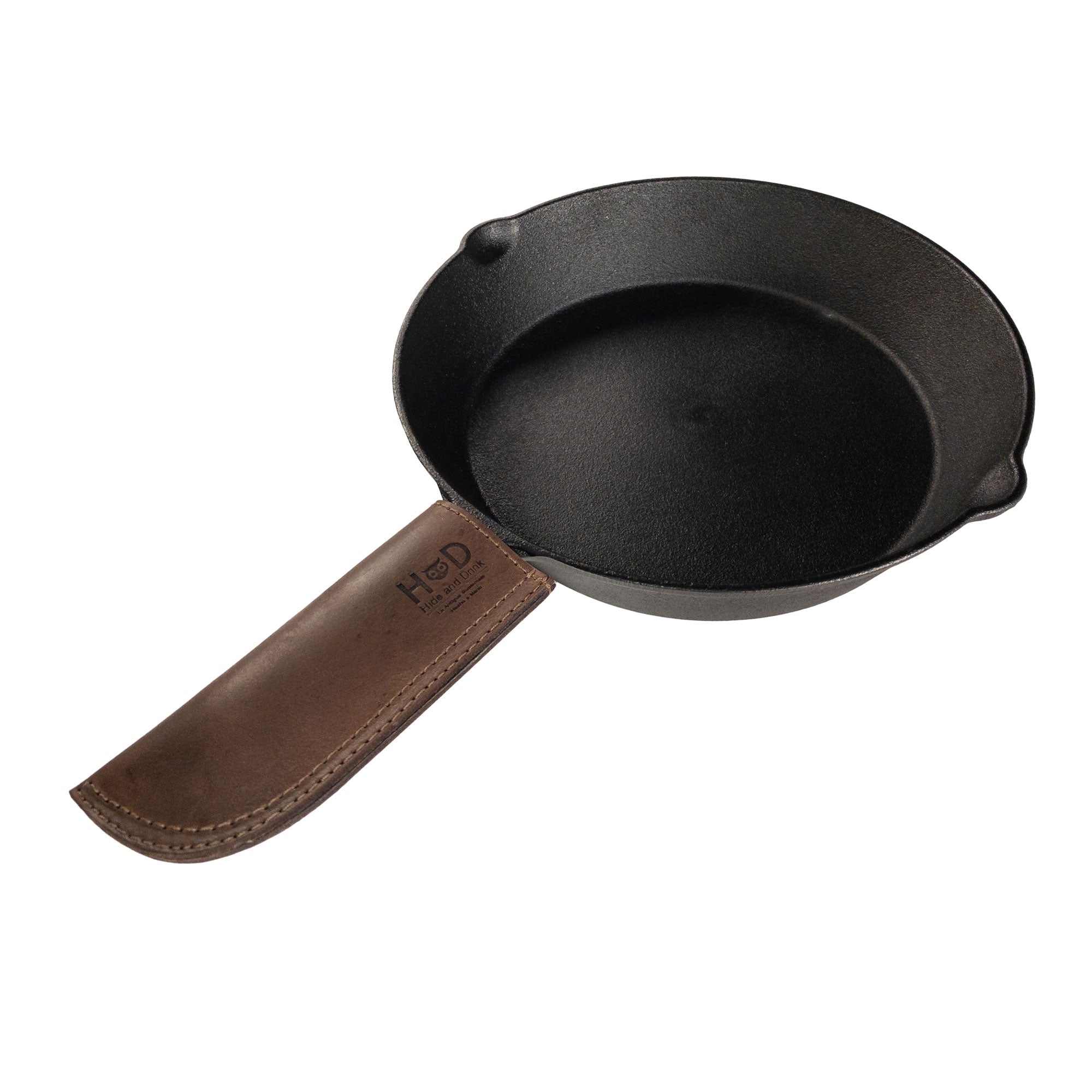 Hot Pan Handle Cover by Hide & Drink, designed for a cast iron skillet with a sturdy grip. Crafted from full grain leather, this durable accessory is handmade in La Antigua Guatemala & Oaxaca Mexico.