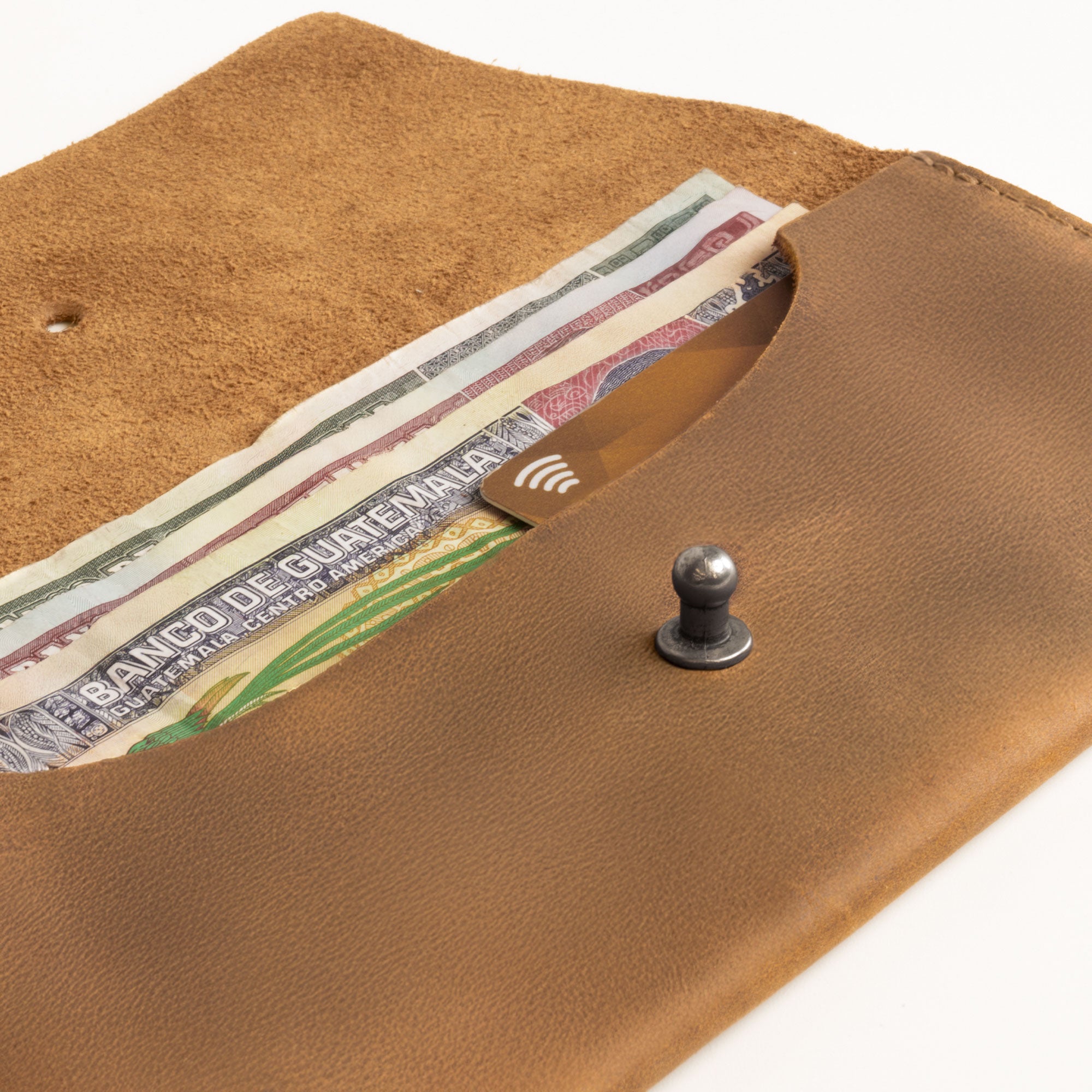 The Long Utility Pouch by Hide & Drink filled with cash and coins, displaying its functional design and upscale style for everyday organization.