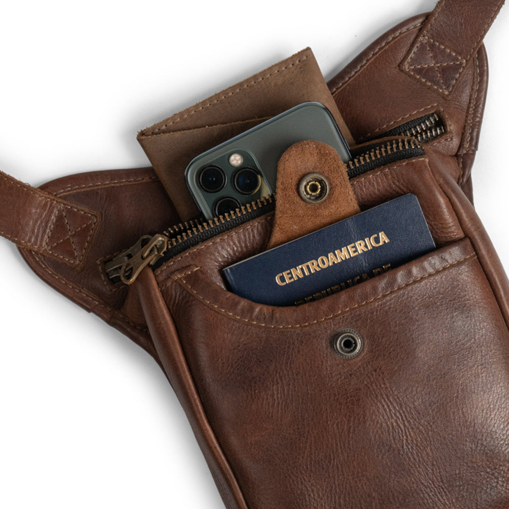 Essential Waist Bag by Hide & Drink, showcasing an adjustable belt and generous storage with unique compartments, crafted from fine full grain leather. Perfect for organizing money and essentials, this bag represents the dedication of small batch production and artisan expertise, handmade in La Antigua Guatemala & Oaxaca Mexico.