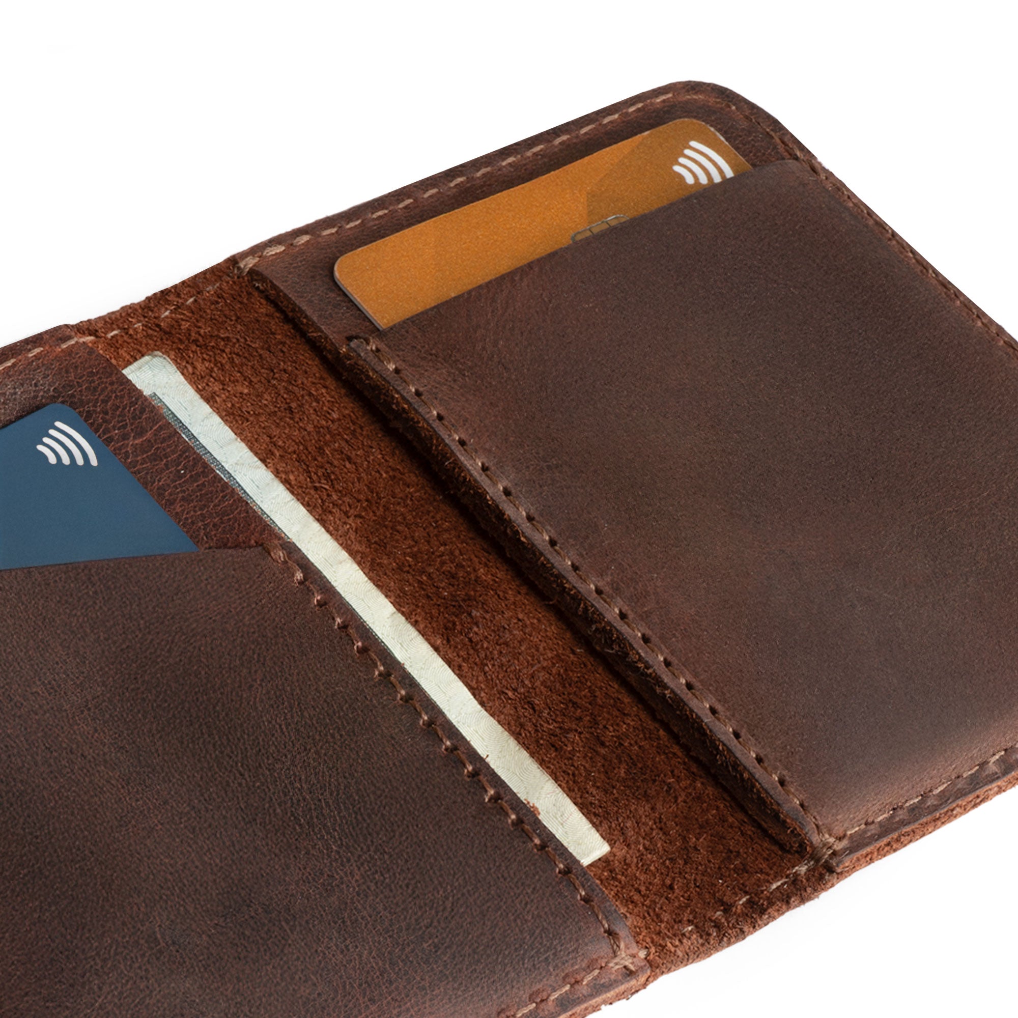 Close-up of Hide & Drink Bifold Wallet showing card slots and cash pocket, highlighting its practical design as a vintage front pocket wallet made from durable full grain leather.